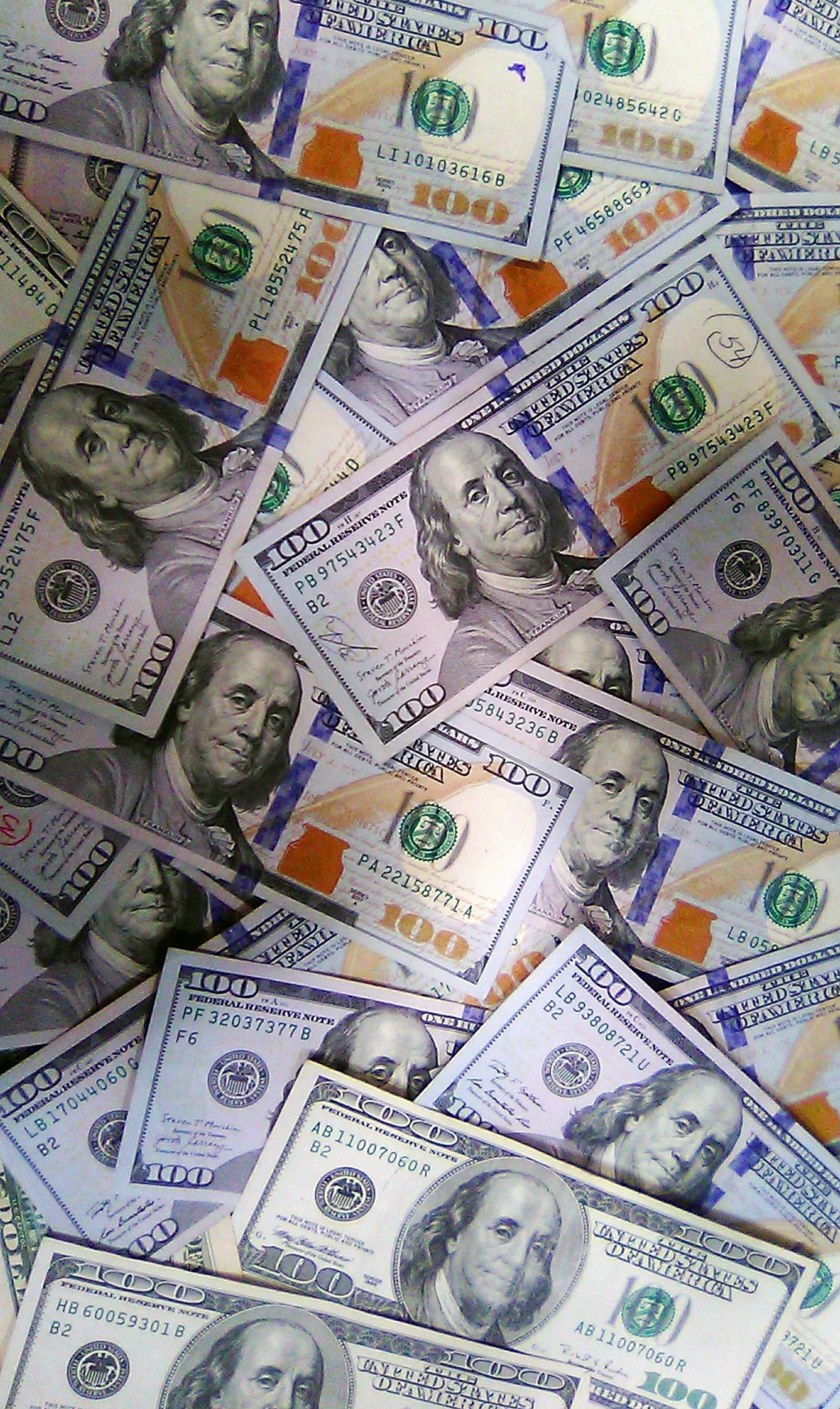 3000x5031 A pile of twenty dollar bills laying on top of each other photo
