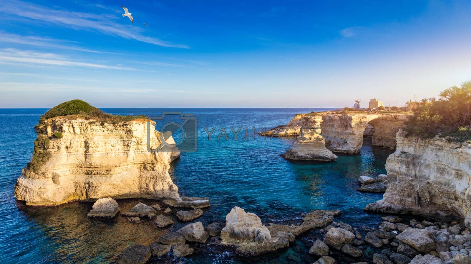 1600x900 Stunning seascape with cliffs rocky arch and stacks (Faraglioni) at Torre Sant Andrea, Salento coast, Puglia region, Italy. Beautiful cliffs and sea stacks of Sant'Andrea, Salento, Apulia, Italy
