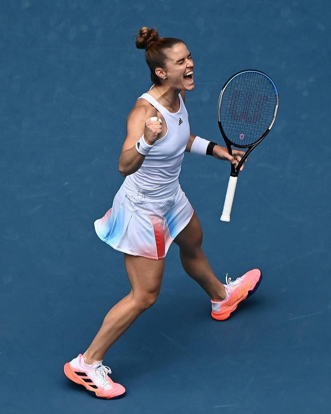 1080x1350 Download Enthusiastic Maria Sakkari Celebrating Victory on Court Wallpaper