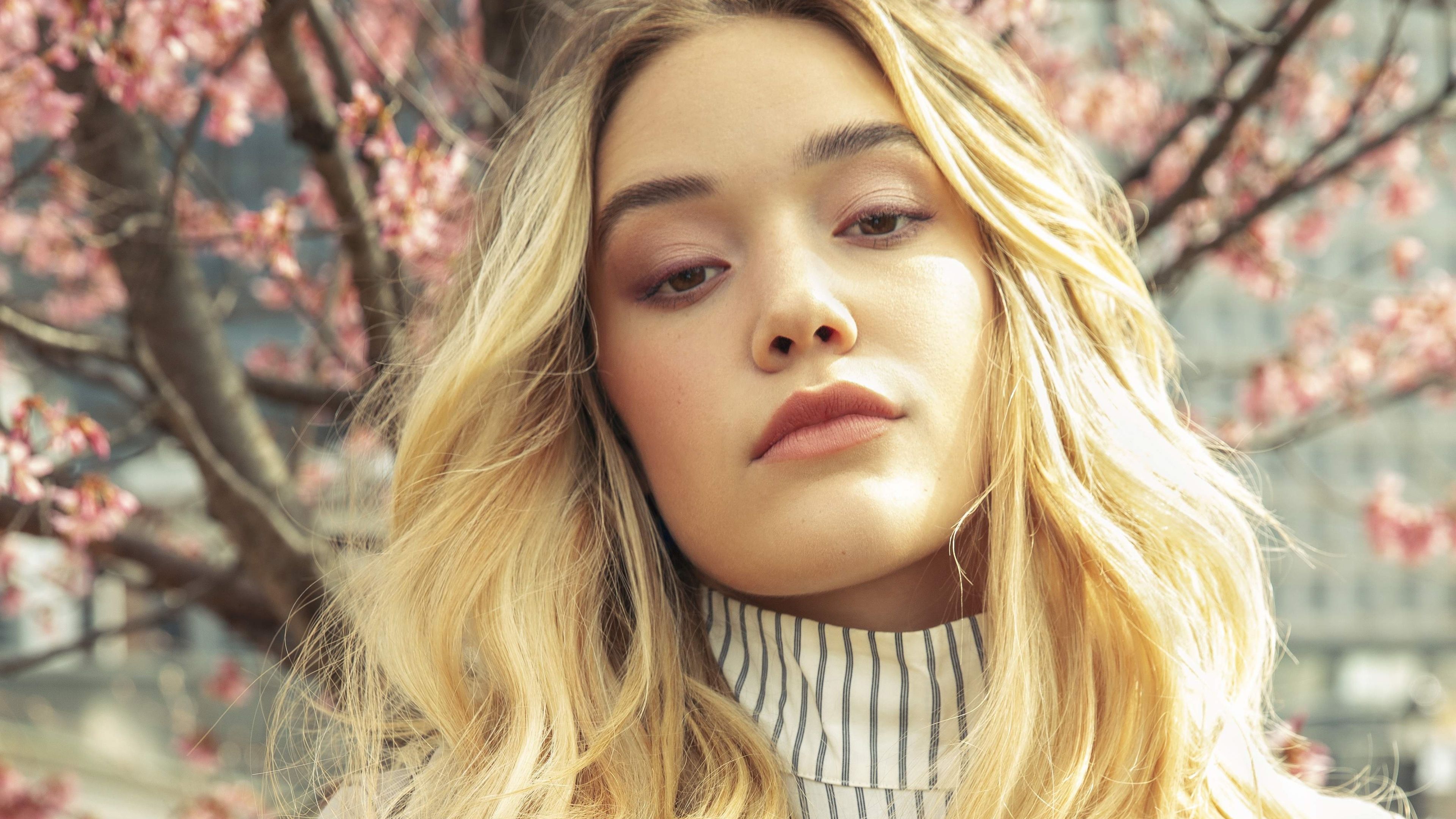 3840x2160 Closeup View Of Blonde Olivia Ponton Girl Model In Blur Sakura Flowers Tree Branches Background 4K HD Girls Wallpaper