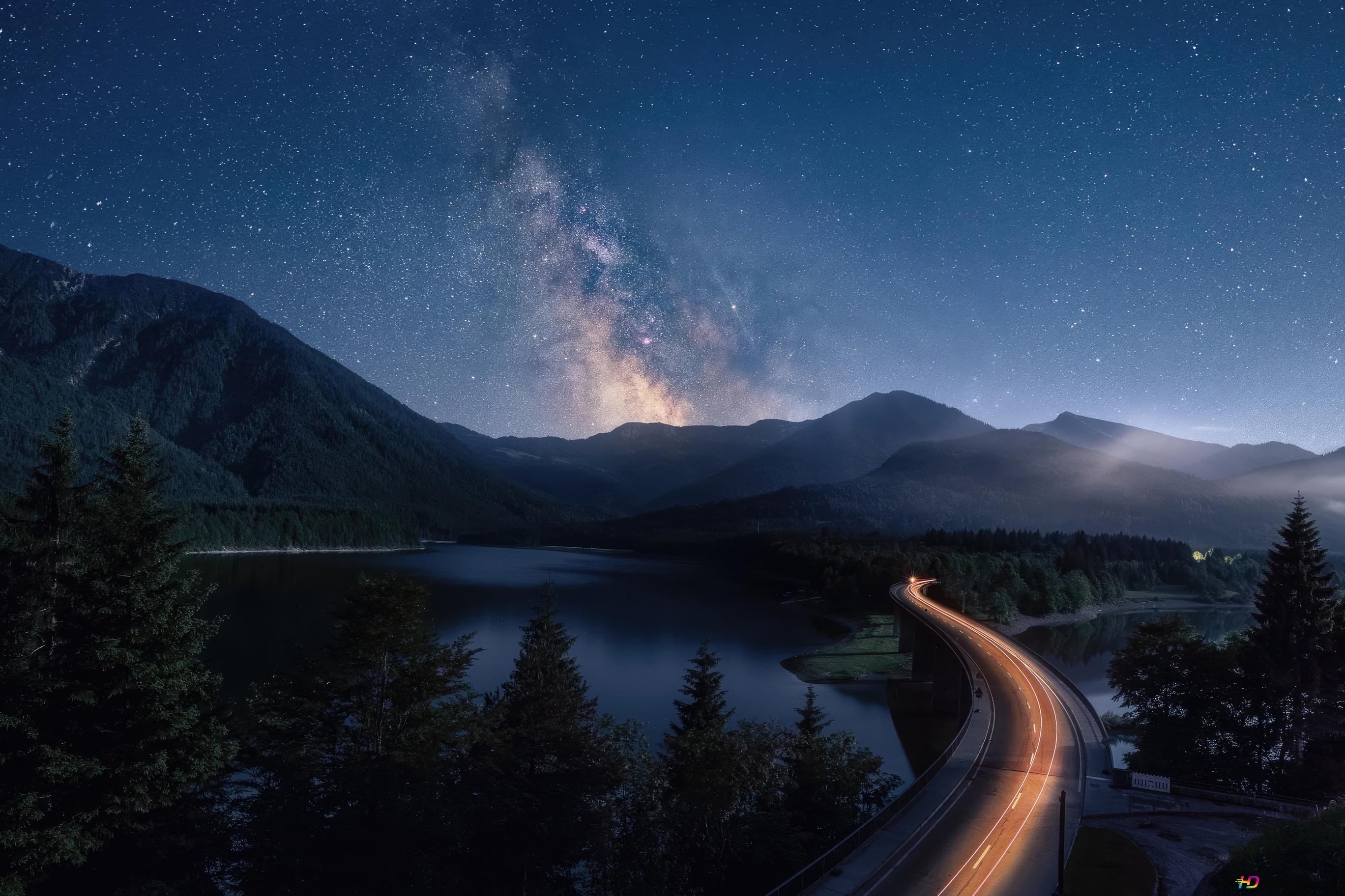 2736x1824 The Milky Way galaxy visible in the night sky over a mountainous 4K wallpaper download