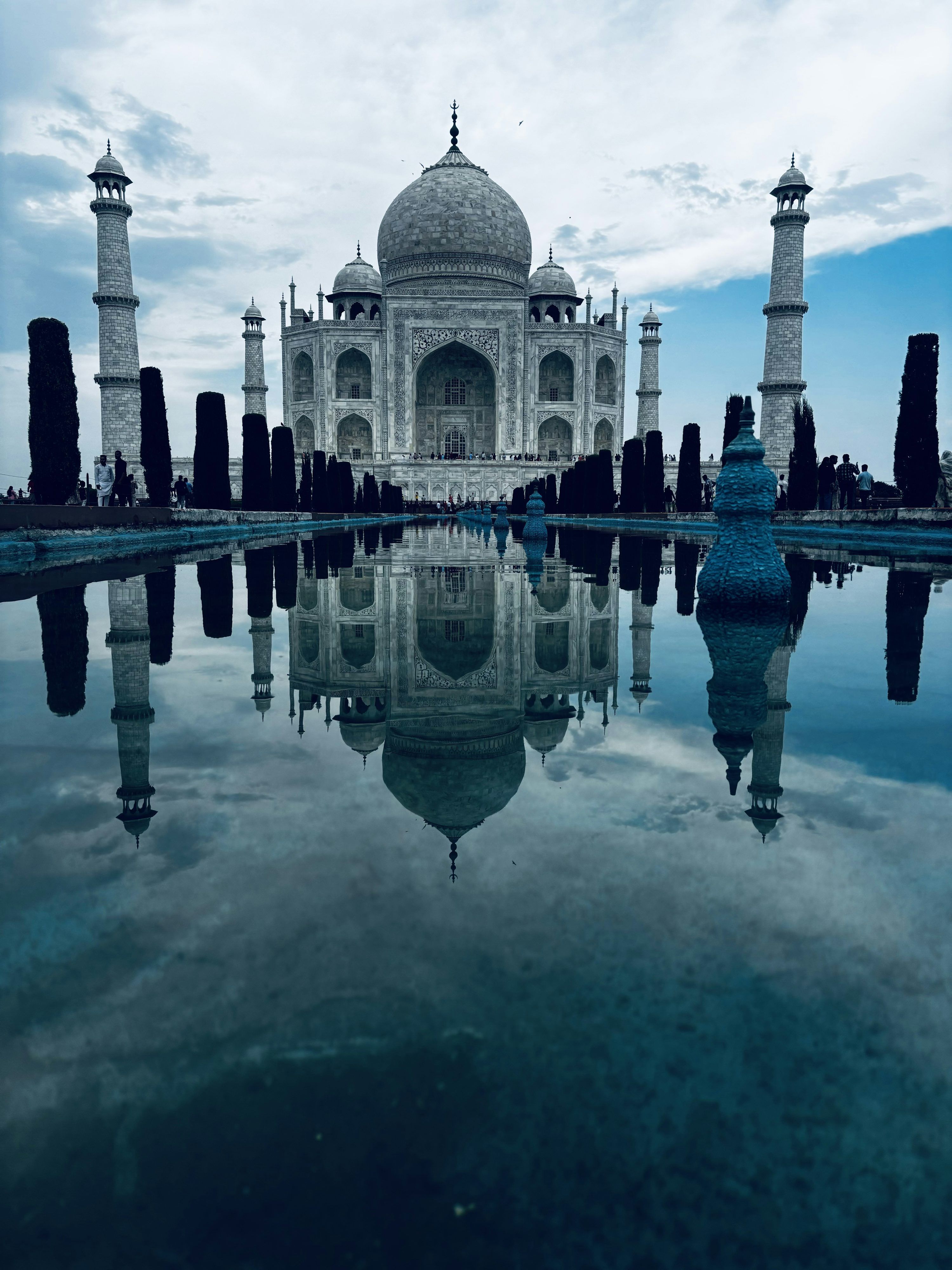 3000x4000 A picture of a building that is reflecting in the water photo