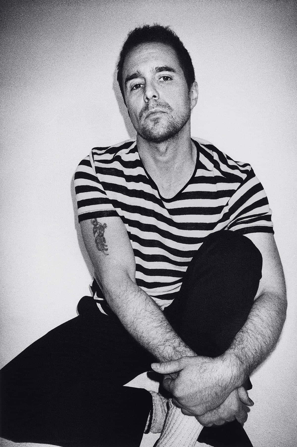 1200x1807 Download Caption: The Enigmatic Sam Rockwell in Black and White Wallpaper
