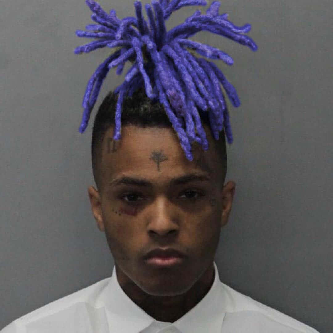 1080x1080 Download Caption: Dynamic Portrait of Xxxtentacion with Blue Hair Wallpaper
