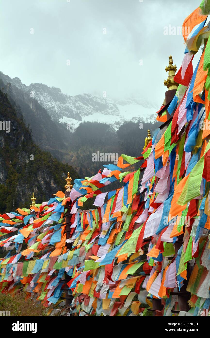 866x1390 Prayer flags hanging high in the mountains at the village of Balagezong near Shangri La. Remote and peaceful place now a tourist area