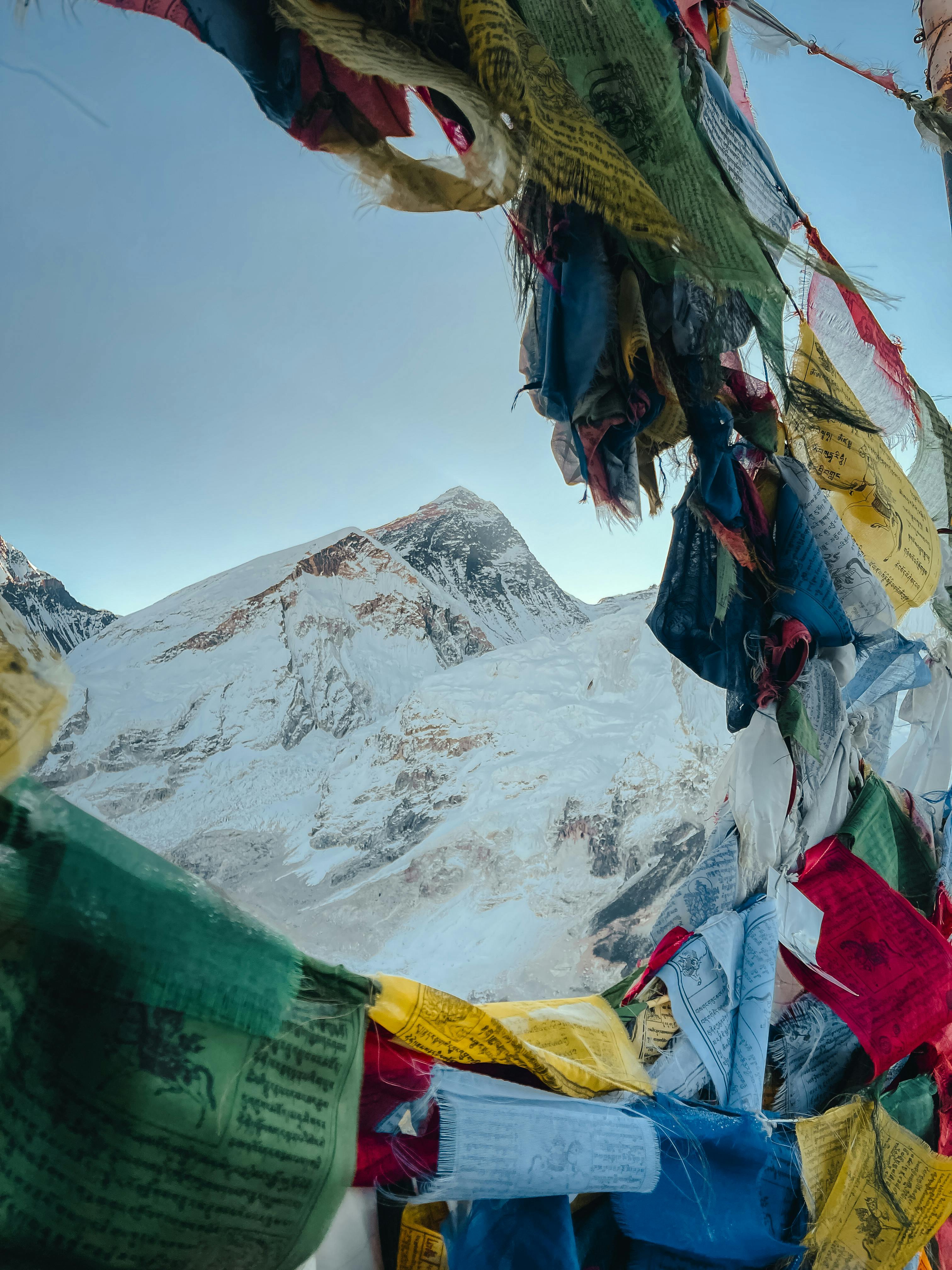 3024x4032 Majestic Mount Everest through Vibrant Prayer Flags · Free