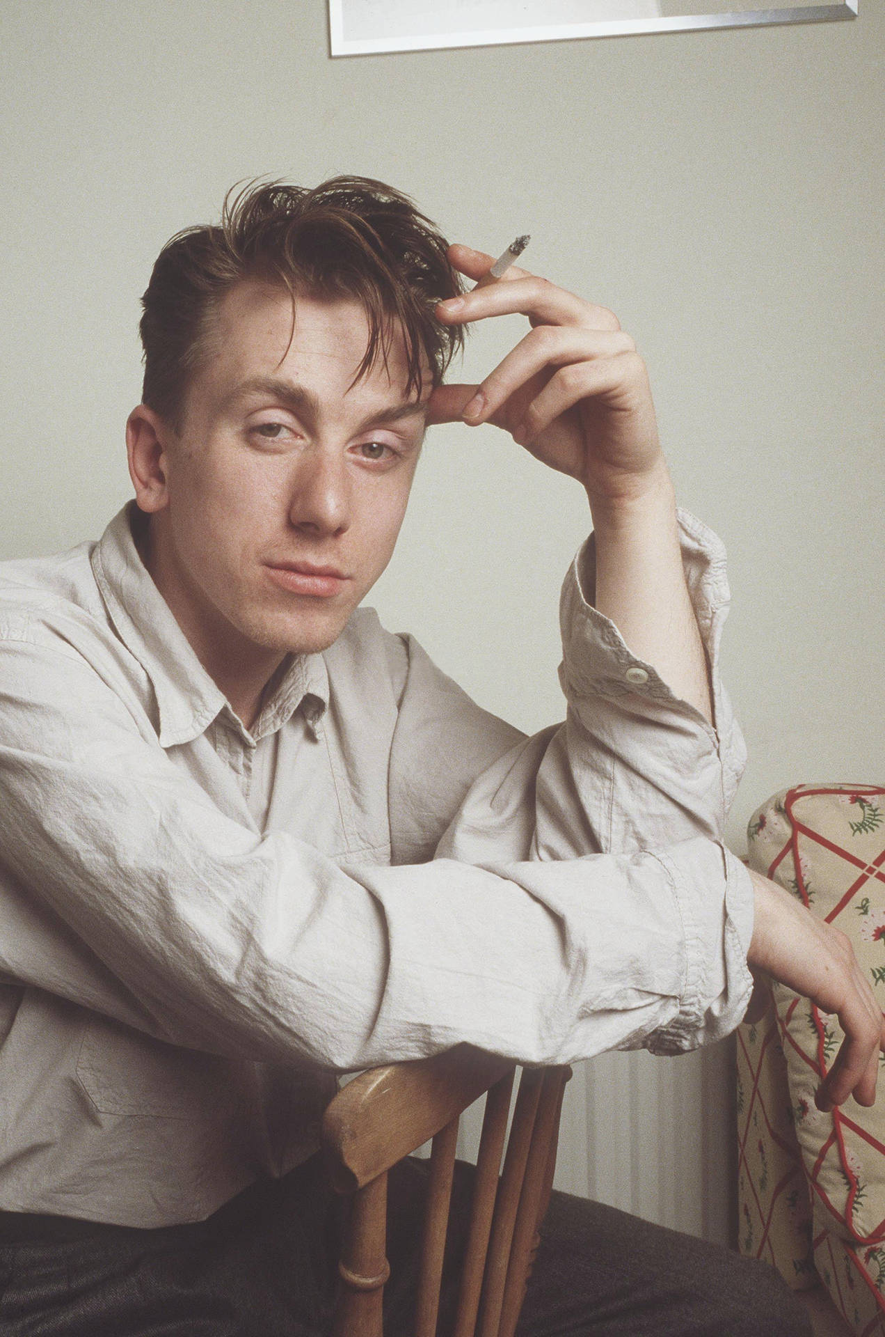 1272x1920 Download British Talent: A Portrait of Young Tim Roth Smoking on Chair Wallpaper