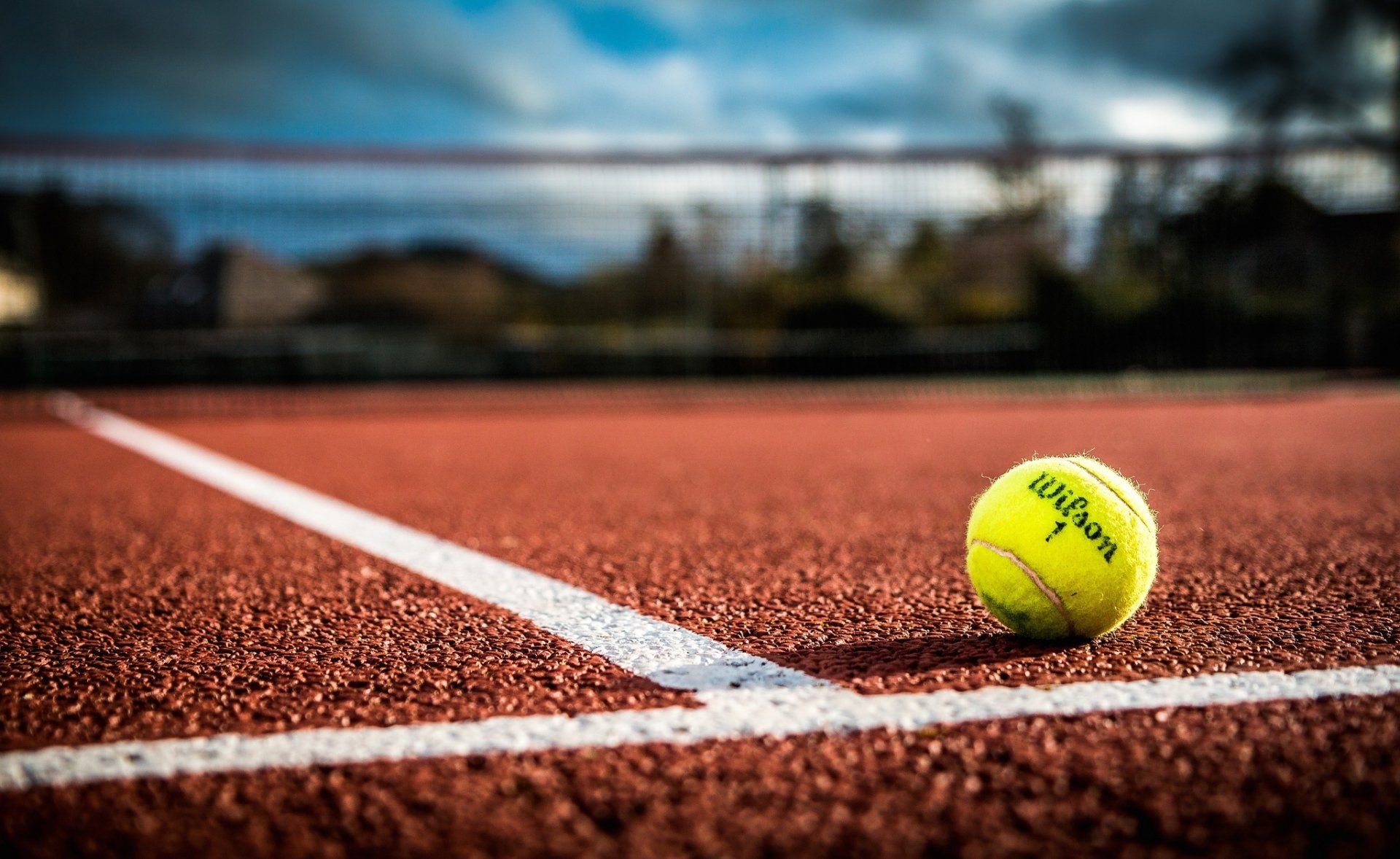 1920x1178 HD Tennis Action: Vibrant Tennis Ball on Court in Sports Wallpaper