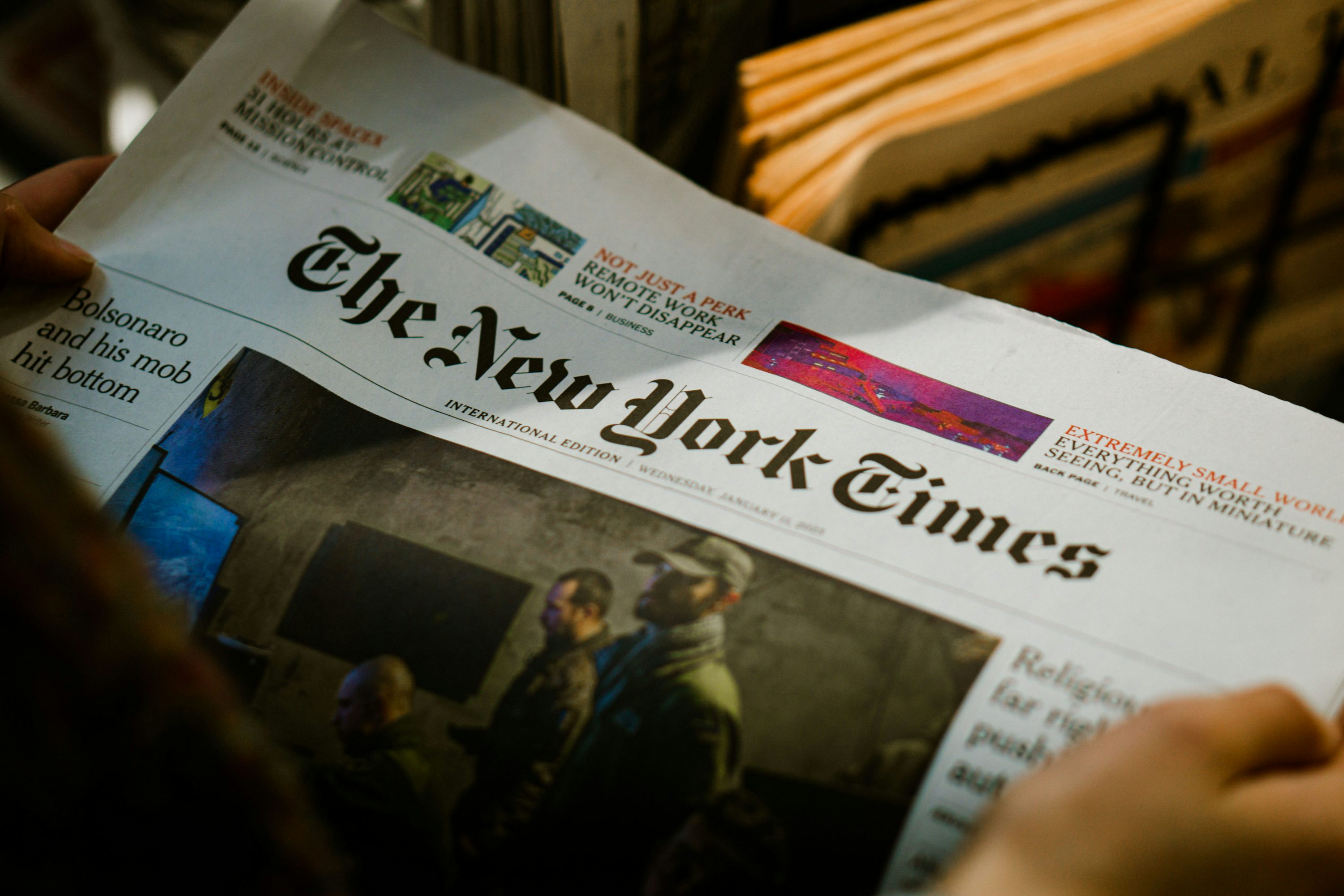 3000x2000 A person reading a newspaper with the new york times on it photo