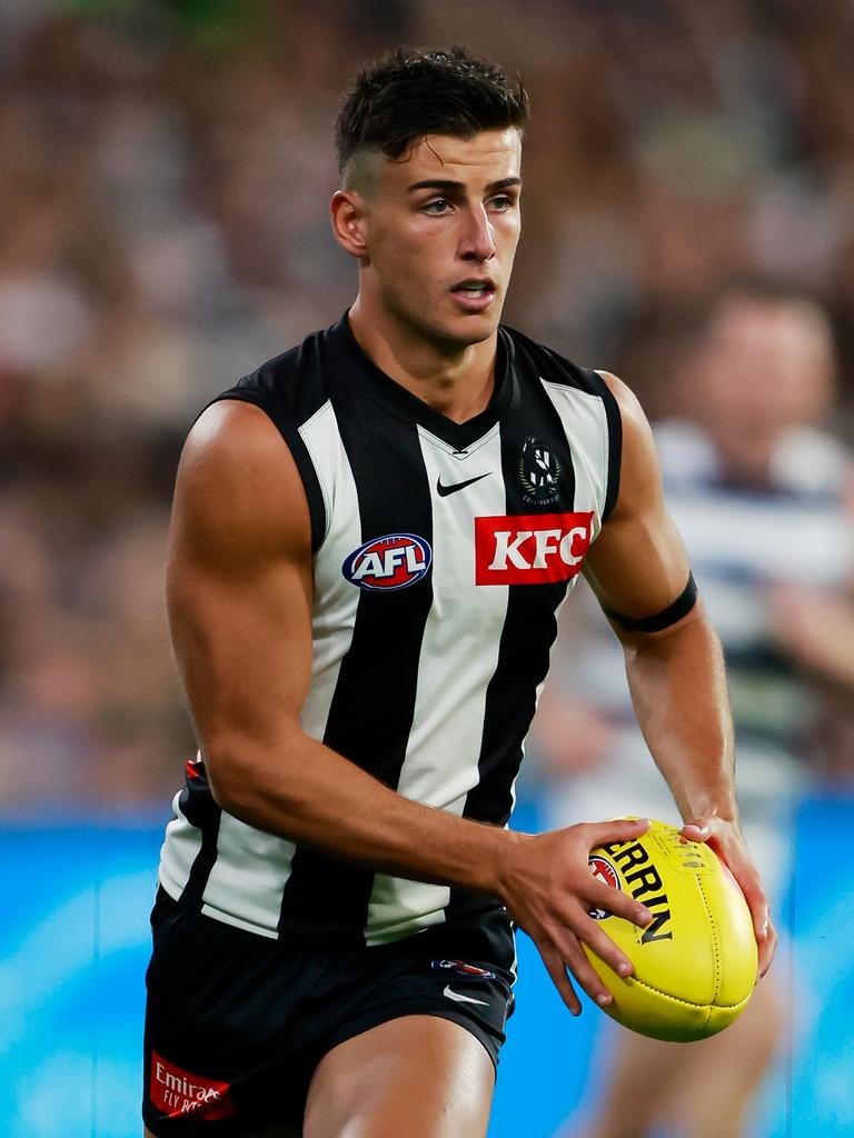 768x1024 AFL 2023: Geelong Cats vs Collingwood Magpies, brothers Josh and Nick Daicos place rose petals on MCG turf in tribute to late grandfather