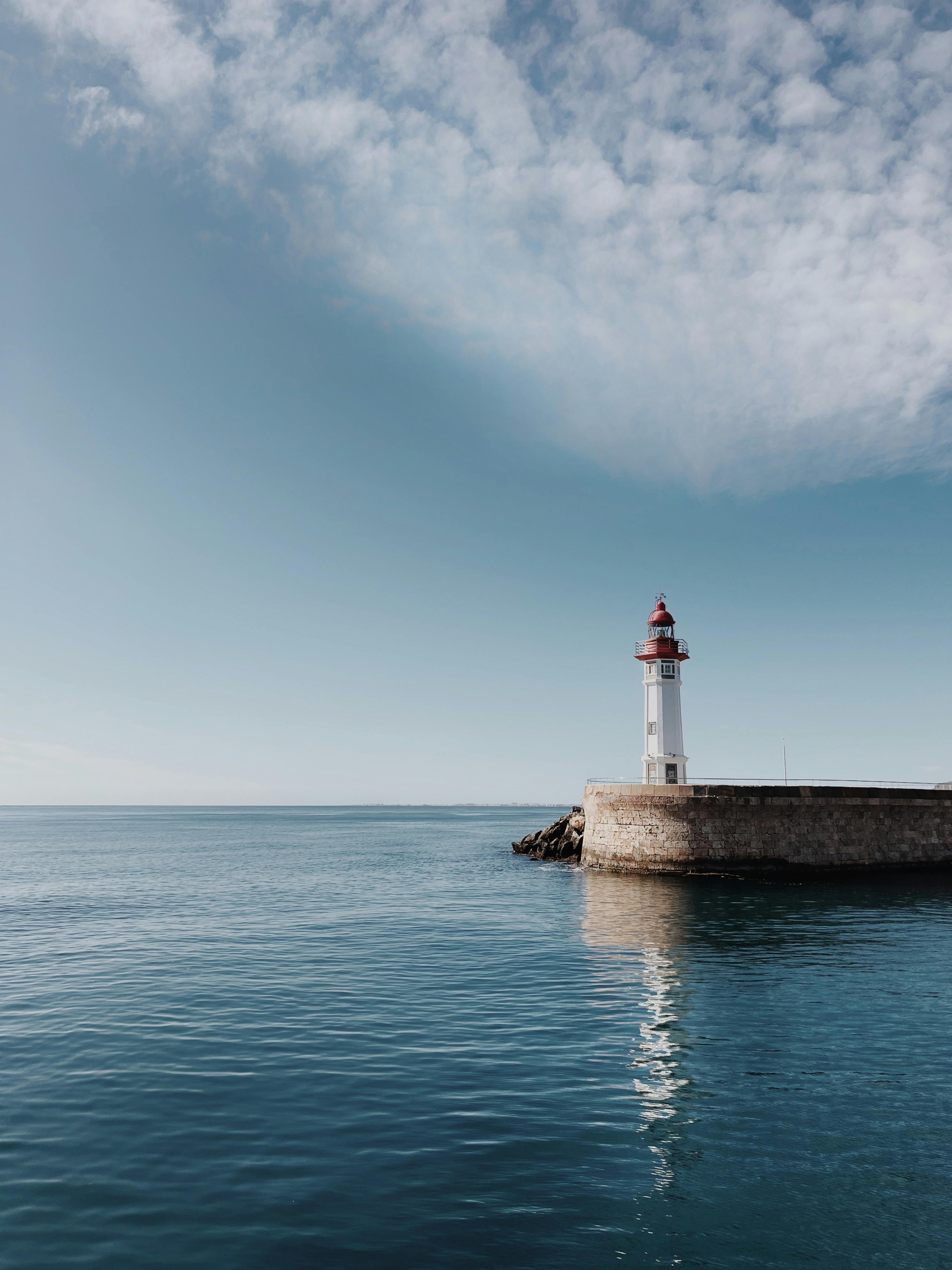 2980x3974 Serene Lighthouse Overlooking Calm Ocean Waters · Free
