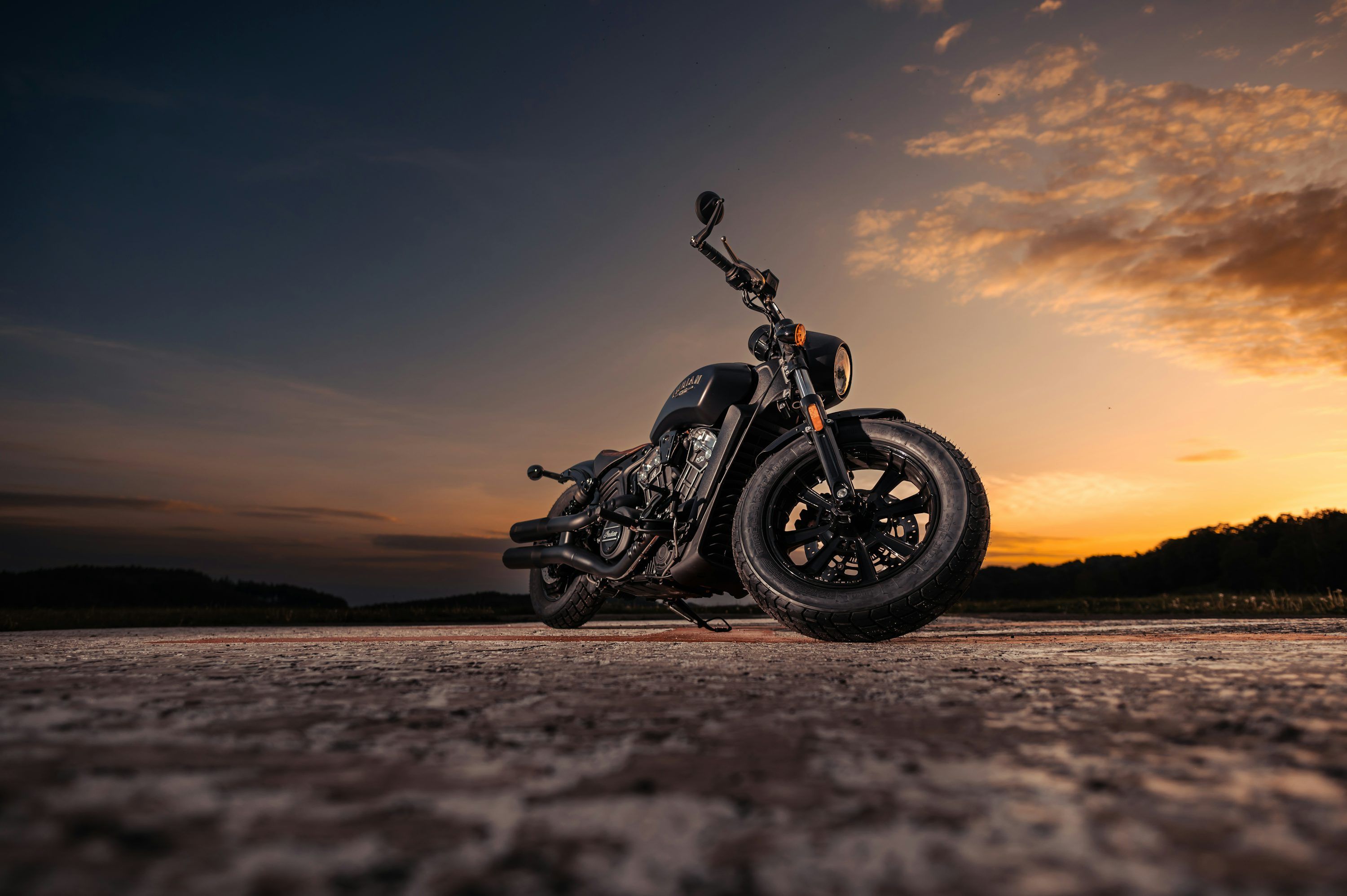 3000x1996 A motorcycle parked on a beach photo