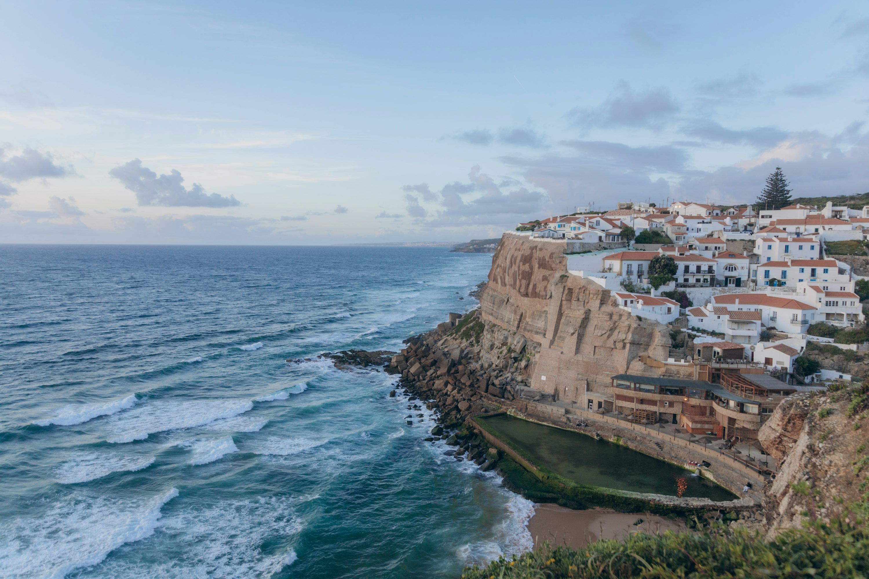 3000x2000 A view of a beach with houses on the cliff photo