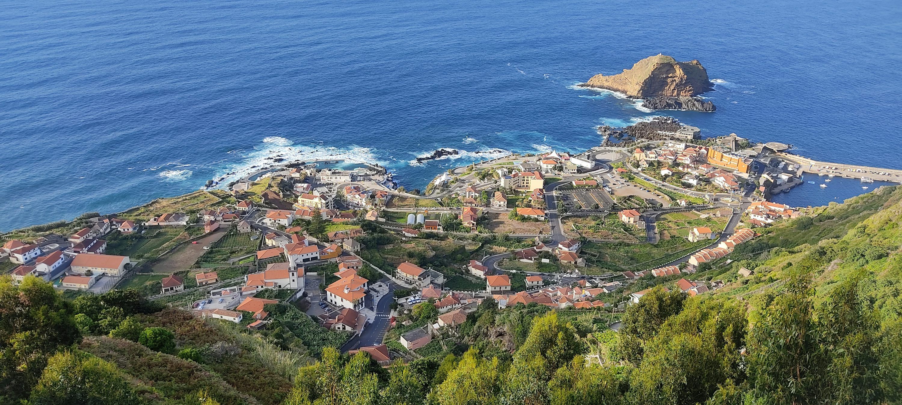 3000x1350 Coastal village nestled along the ocean. photo
