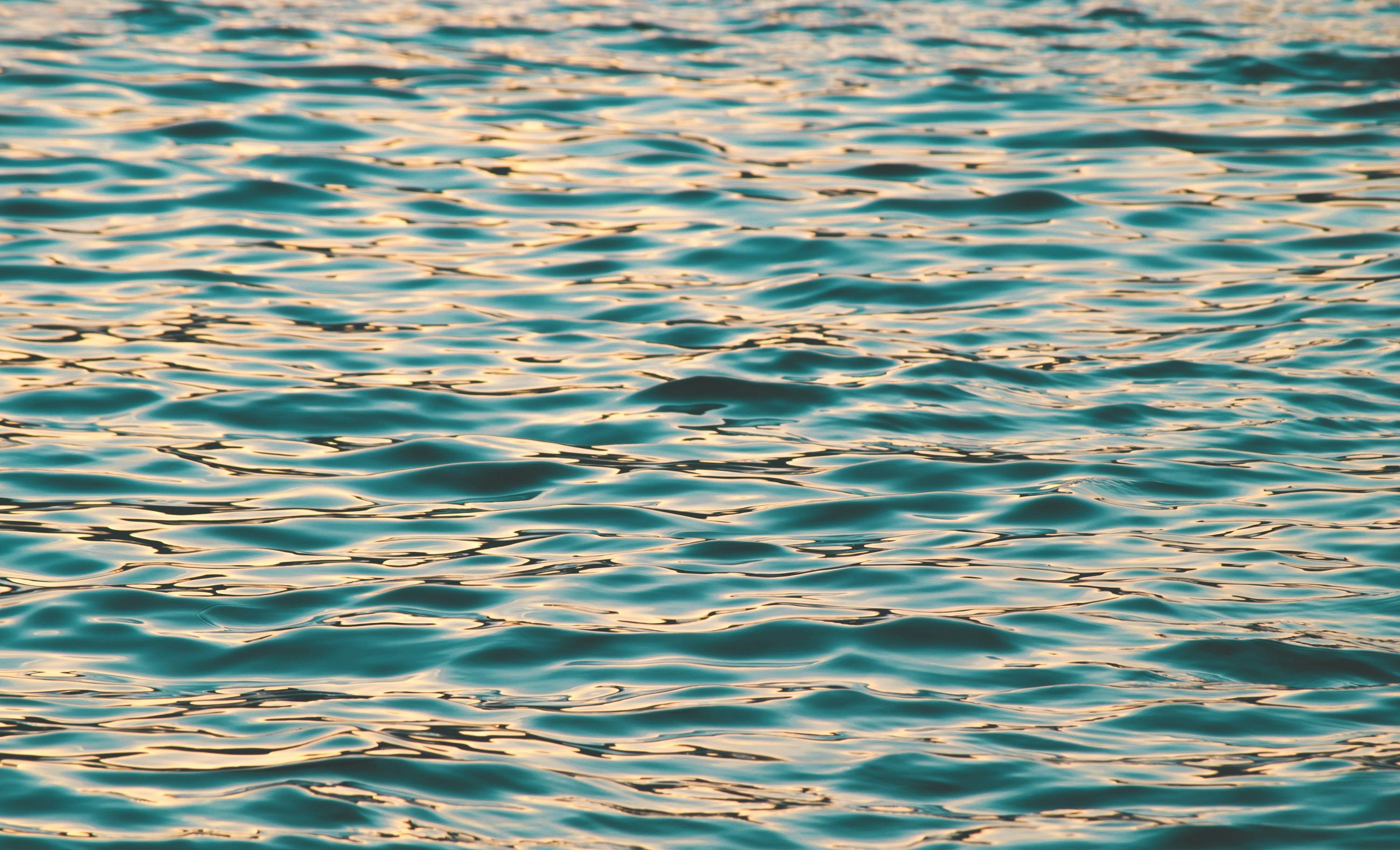 3000x1822 A large body of water with ripples on it photo