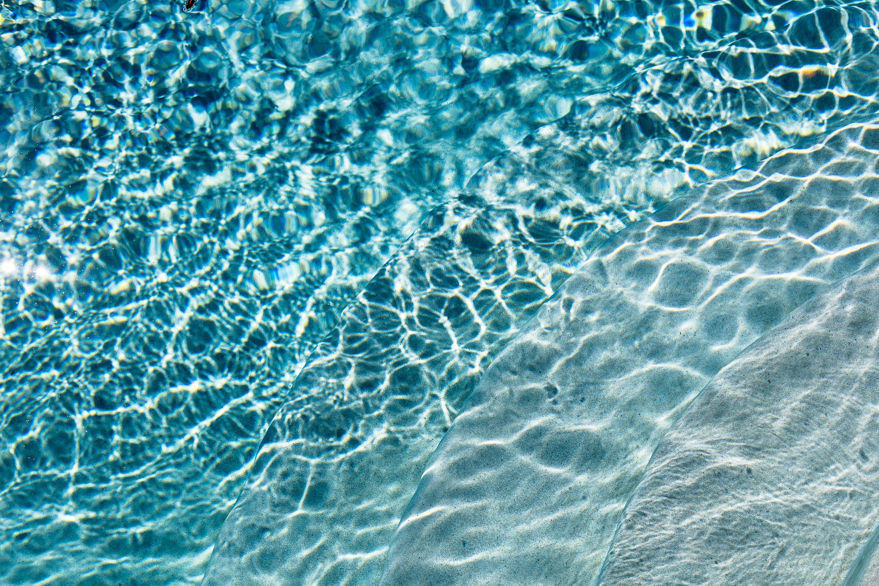 3000x2000 Ripples and reflections dance across the clear water. photo