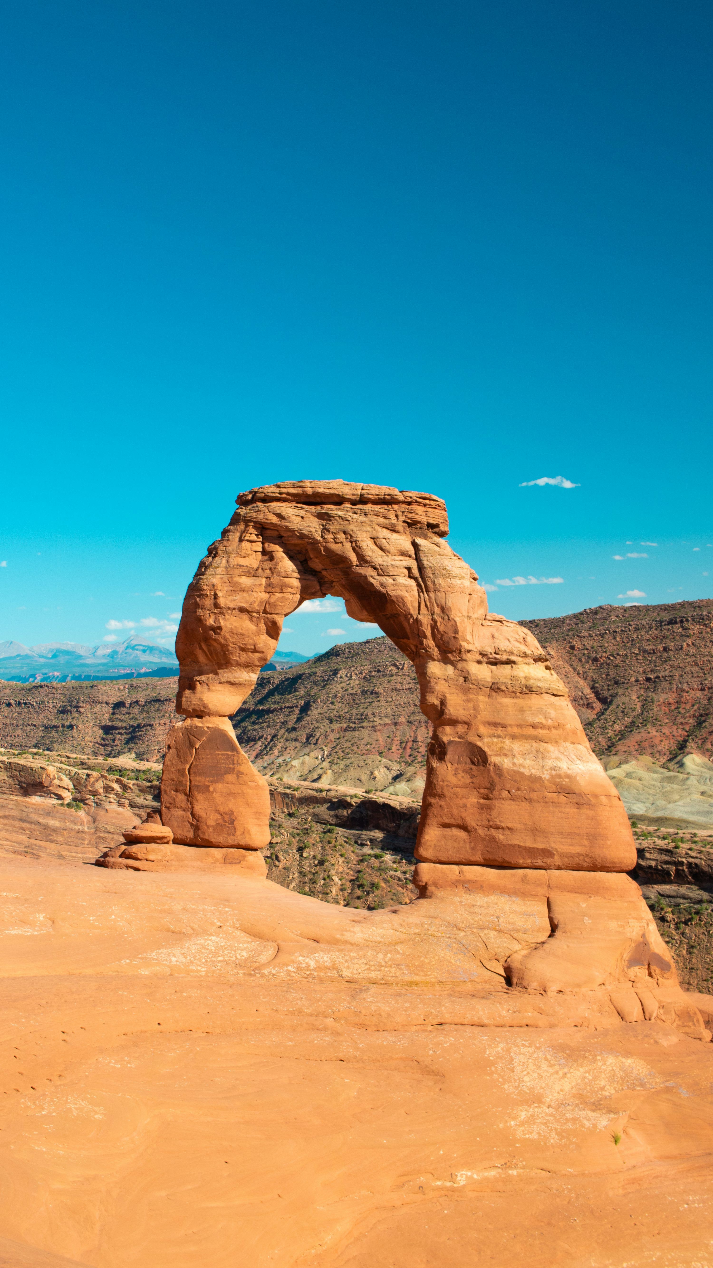 3000x5333 A large rock formation in the middle of a desert photo