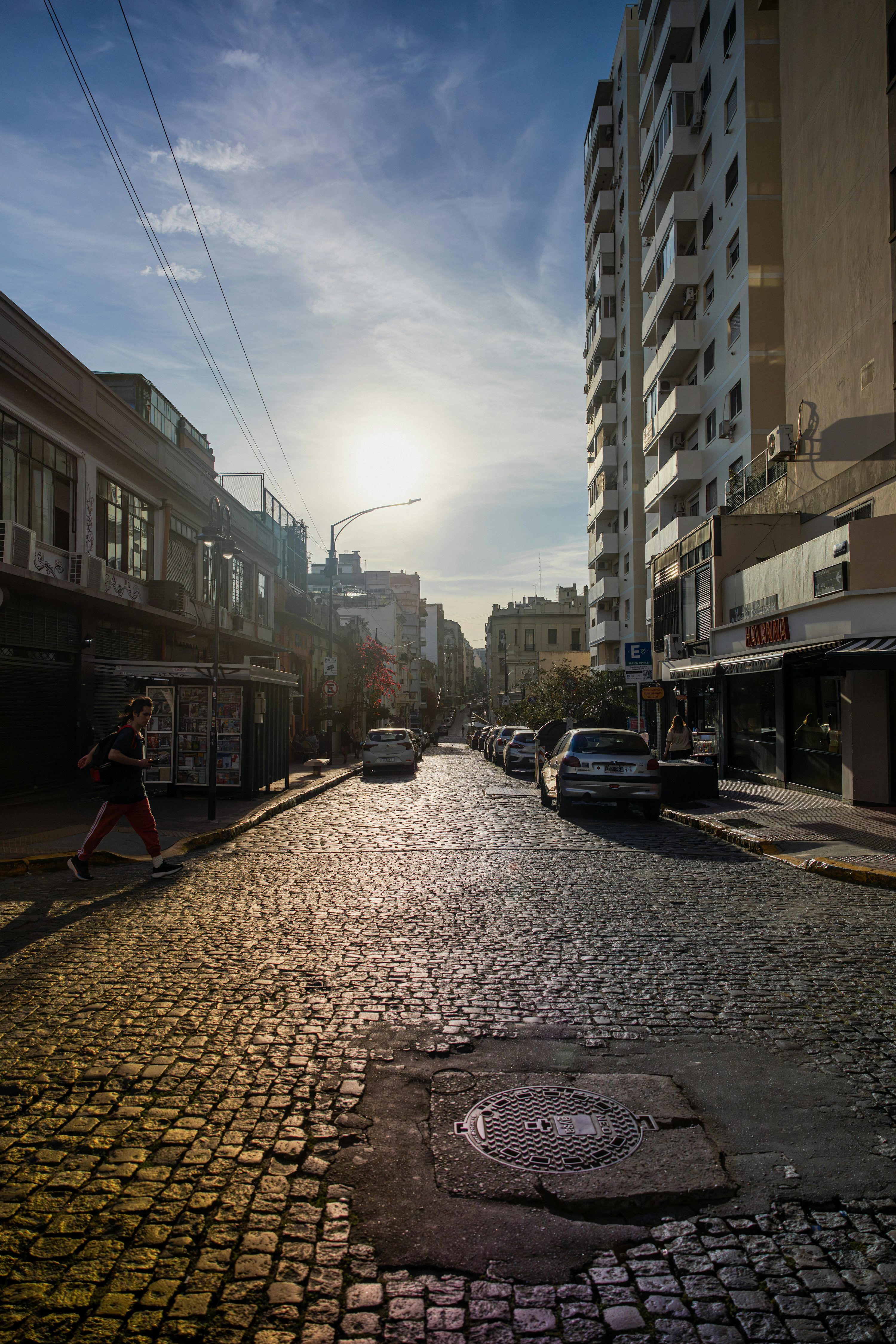 3000x4498 Sun shines on a cobblestone street in a city. photo