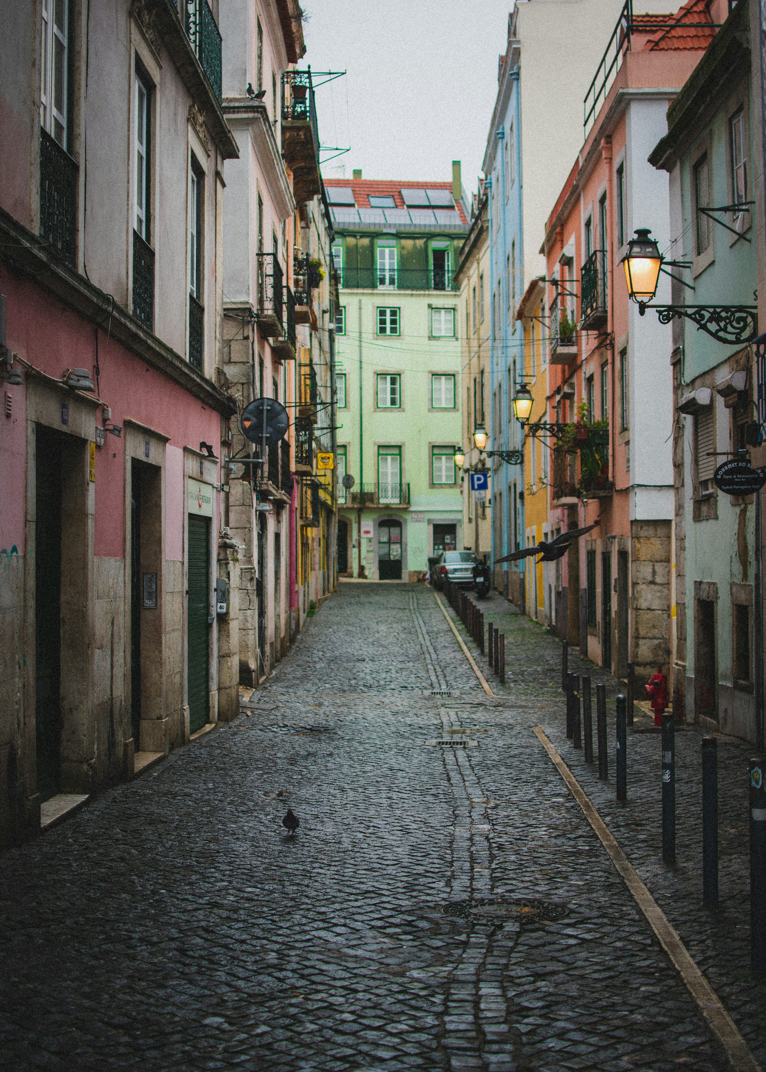 3000x4200 A cobblestone street with buildings on either side of it photo