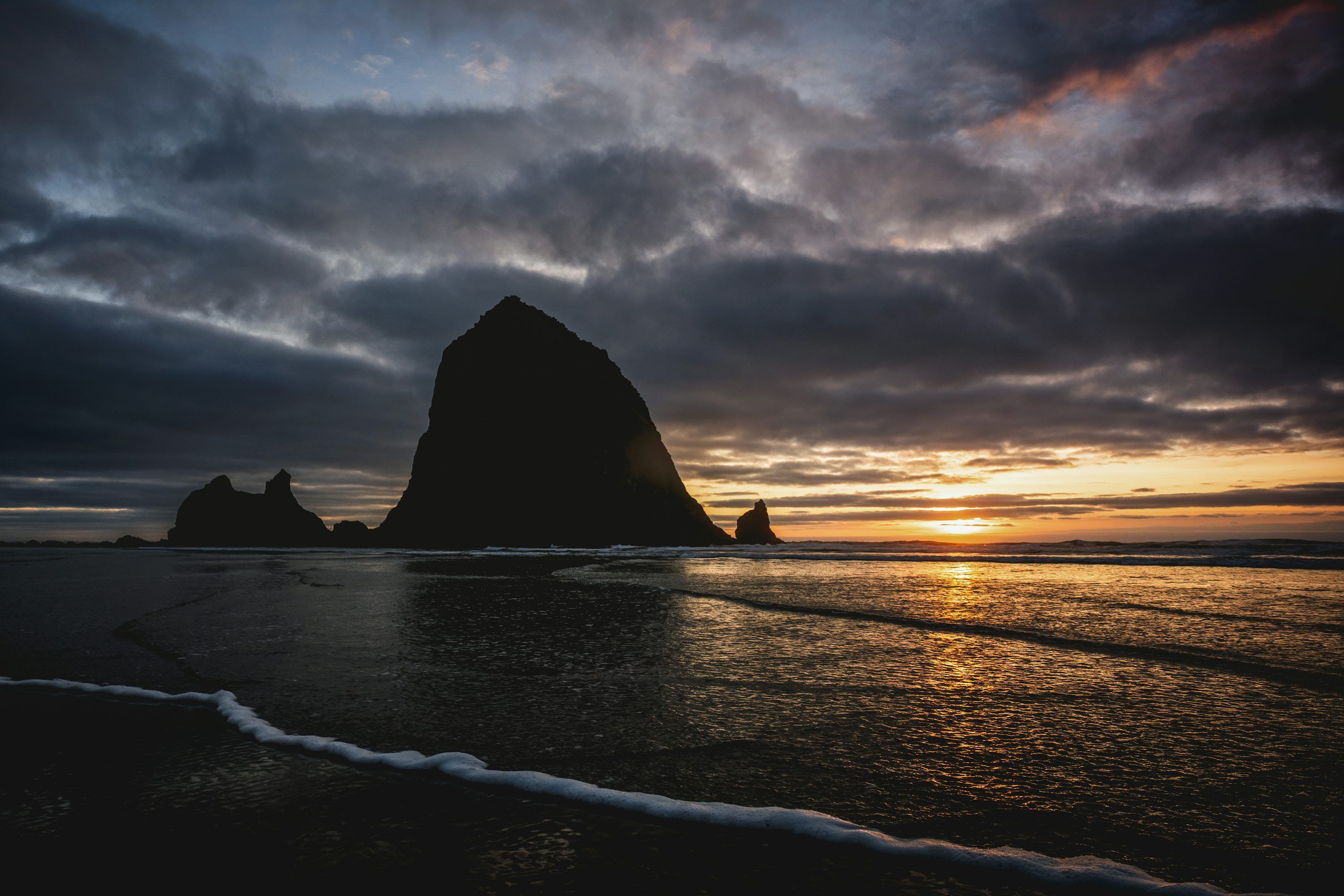 3000x2000 Dramatic sunset over a rocky ocean coastline photo