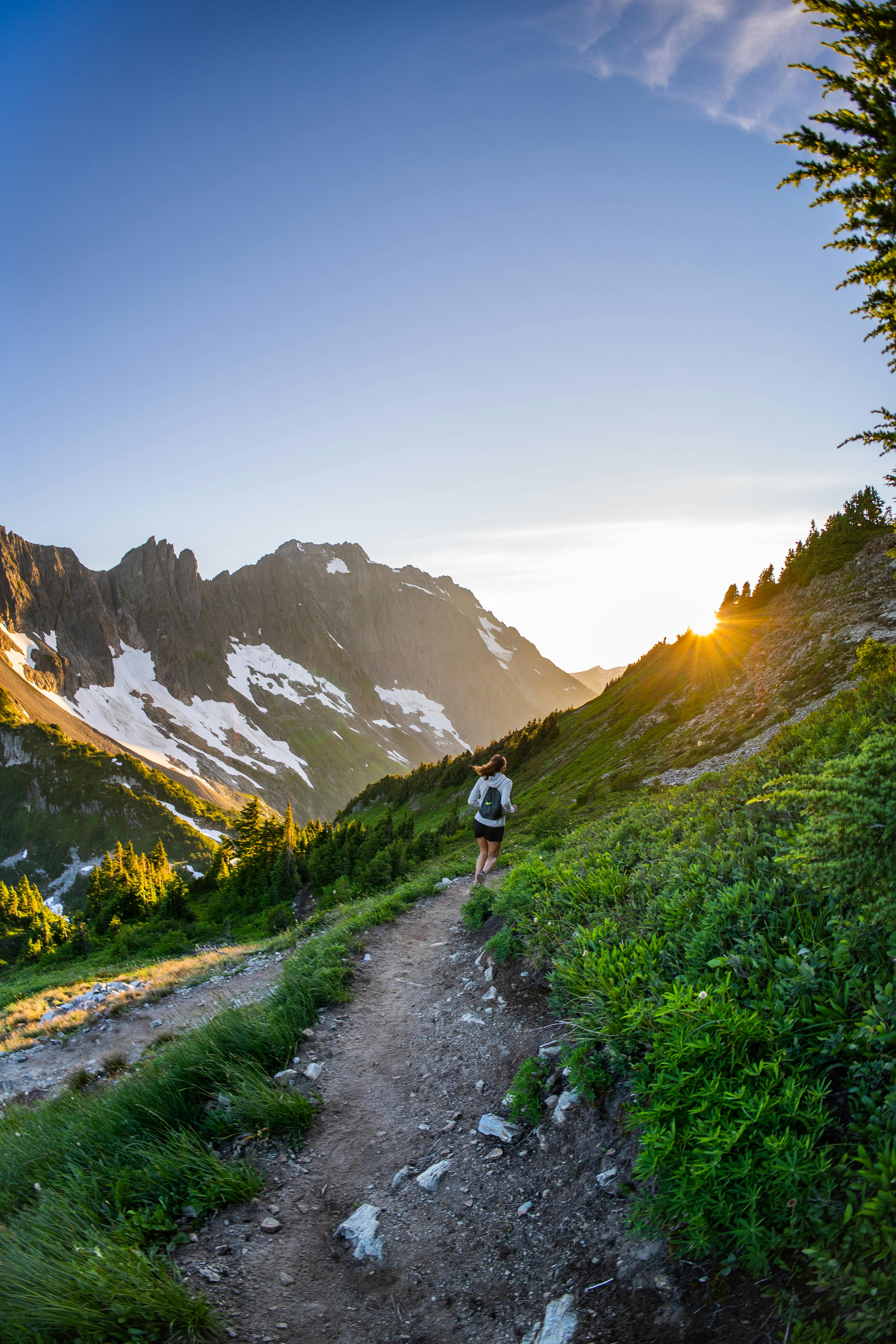 4000x6000 Back View of a Woman Running Up the Mountain Trail · Free