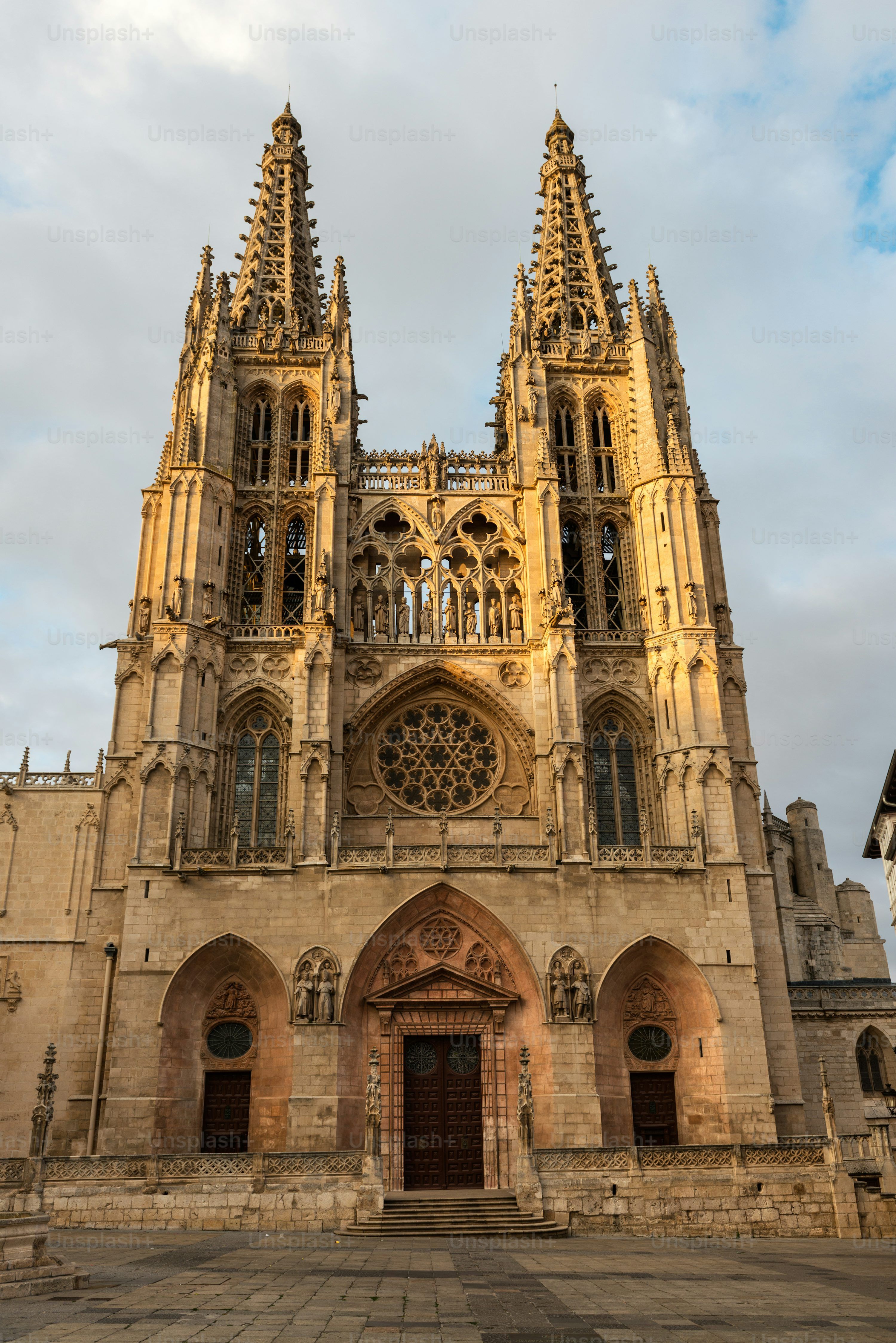 3000x4494 Side View Of The Two Western Flamboyant Spires Of The Gothic Roman Catholic Cathedral In Burgos (1221 1567) Illuminated By The Setting Sun, Spain. Photo