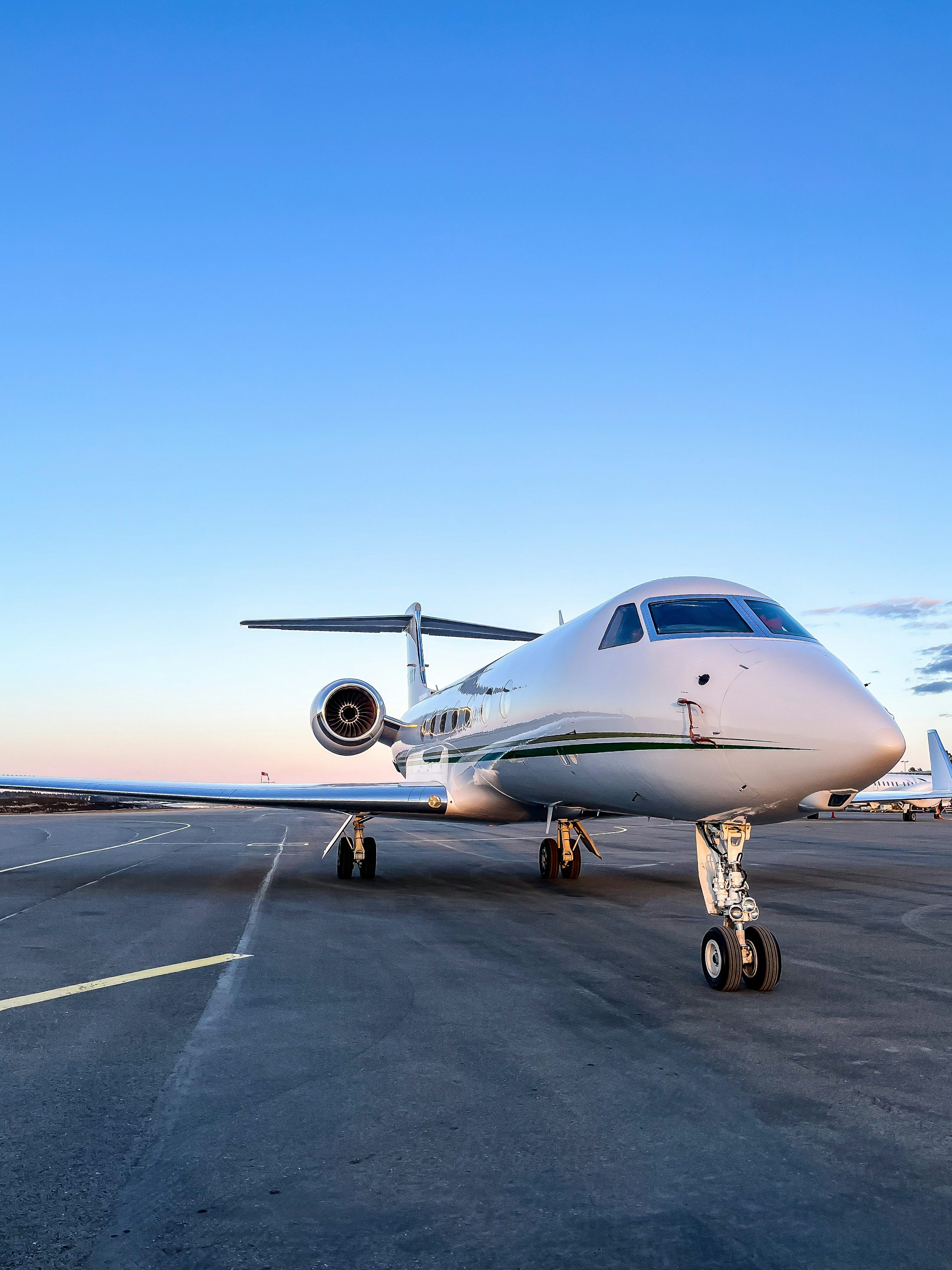 3000x4000 A small white jet sitting on top of an airport tarmac photo