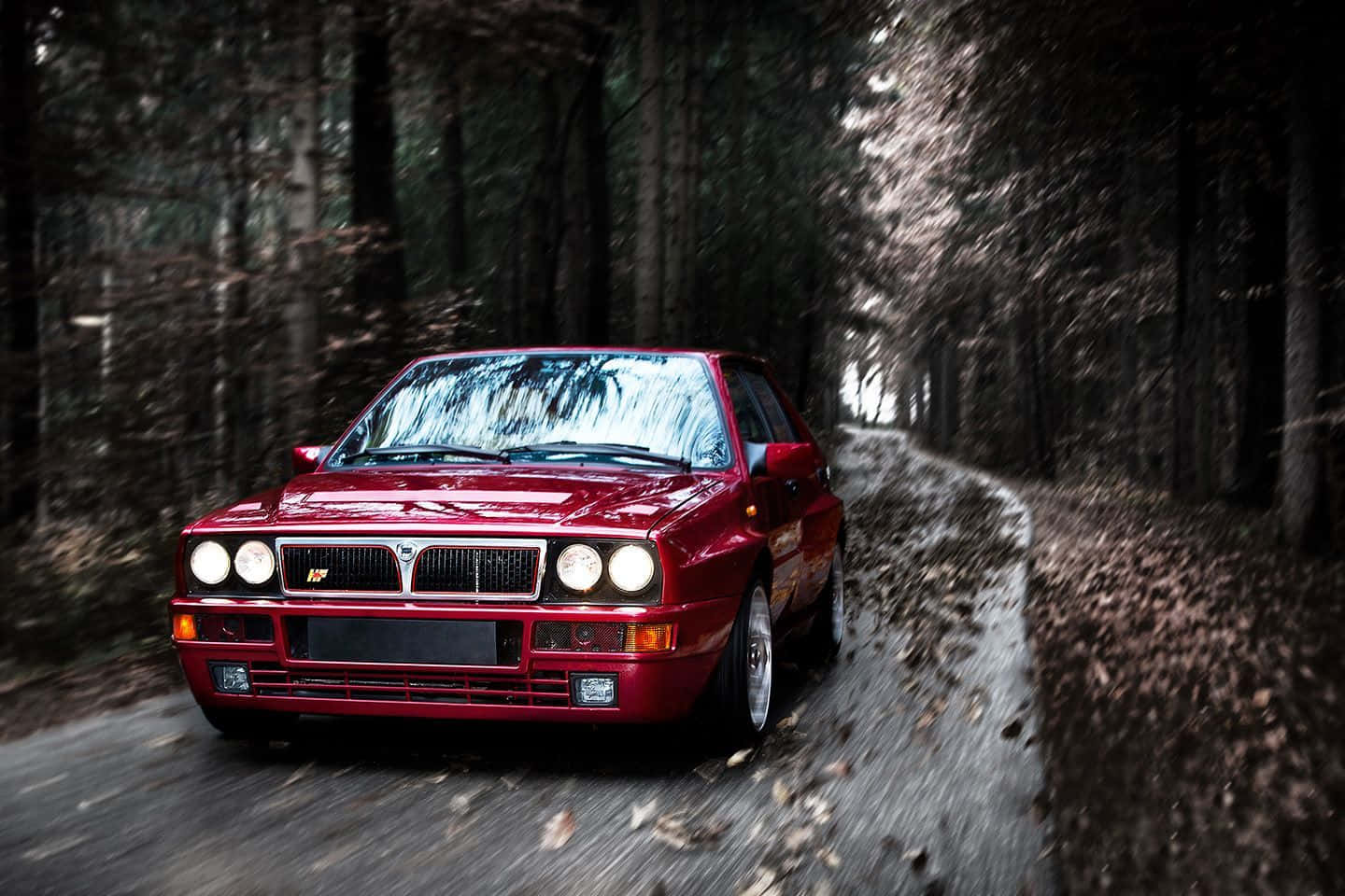 1440x960 Download Sleek Lancia Sports Car on a Scenic Road Wallpaper