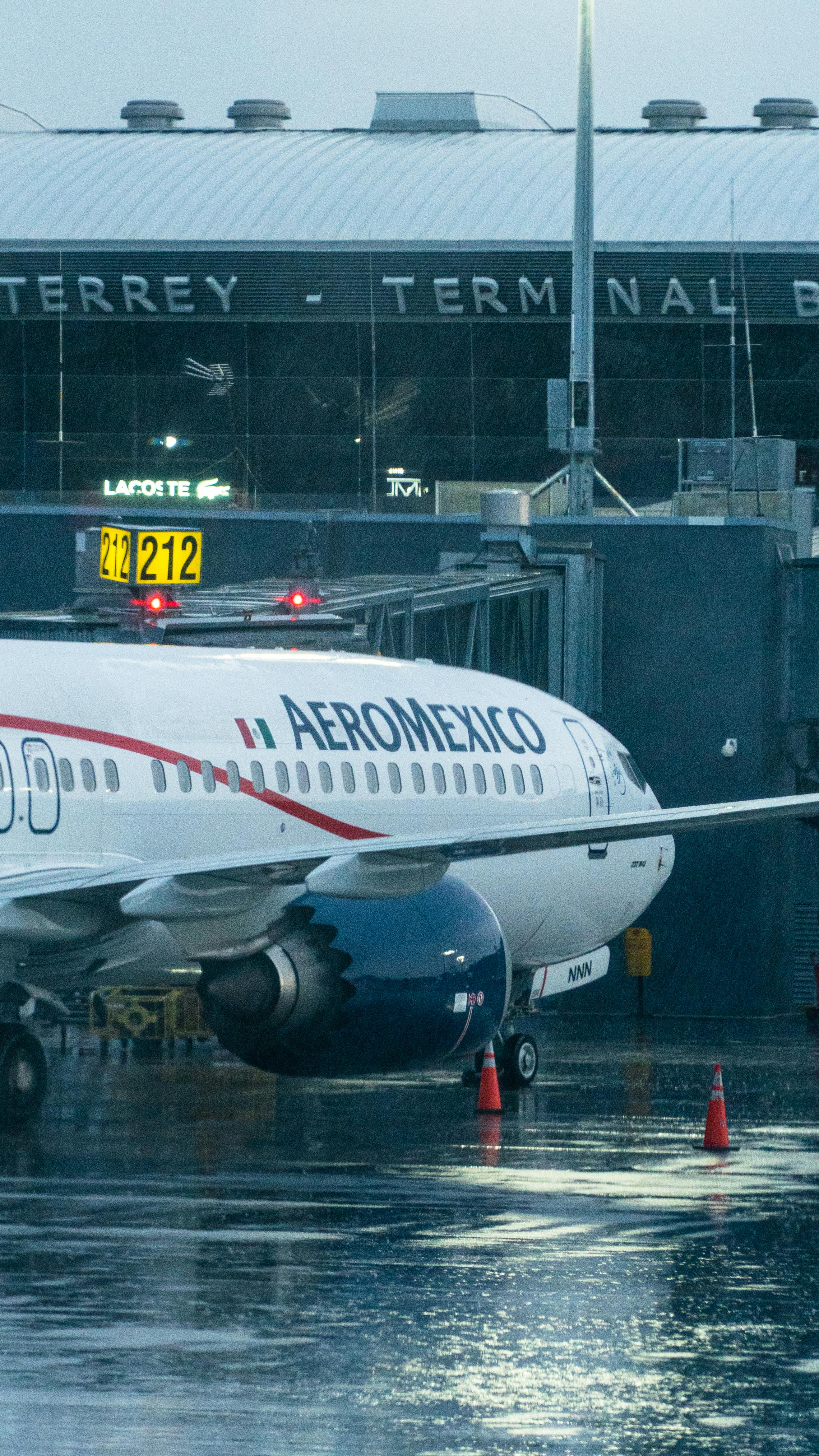 2634x4681 Airplane under Rain on Tarmac in Monterrey Airport · Free