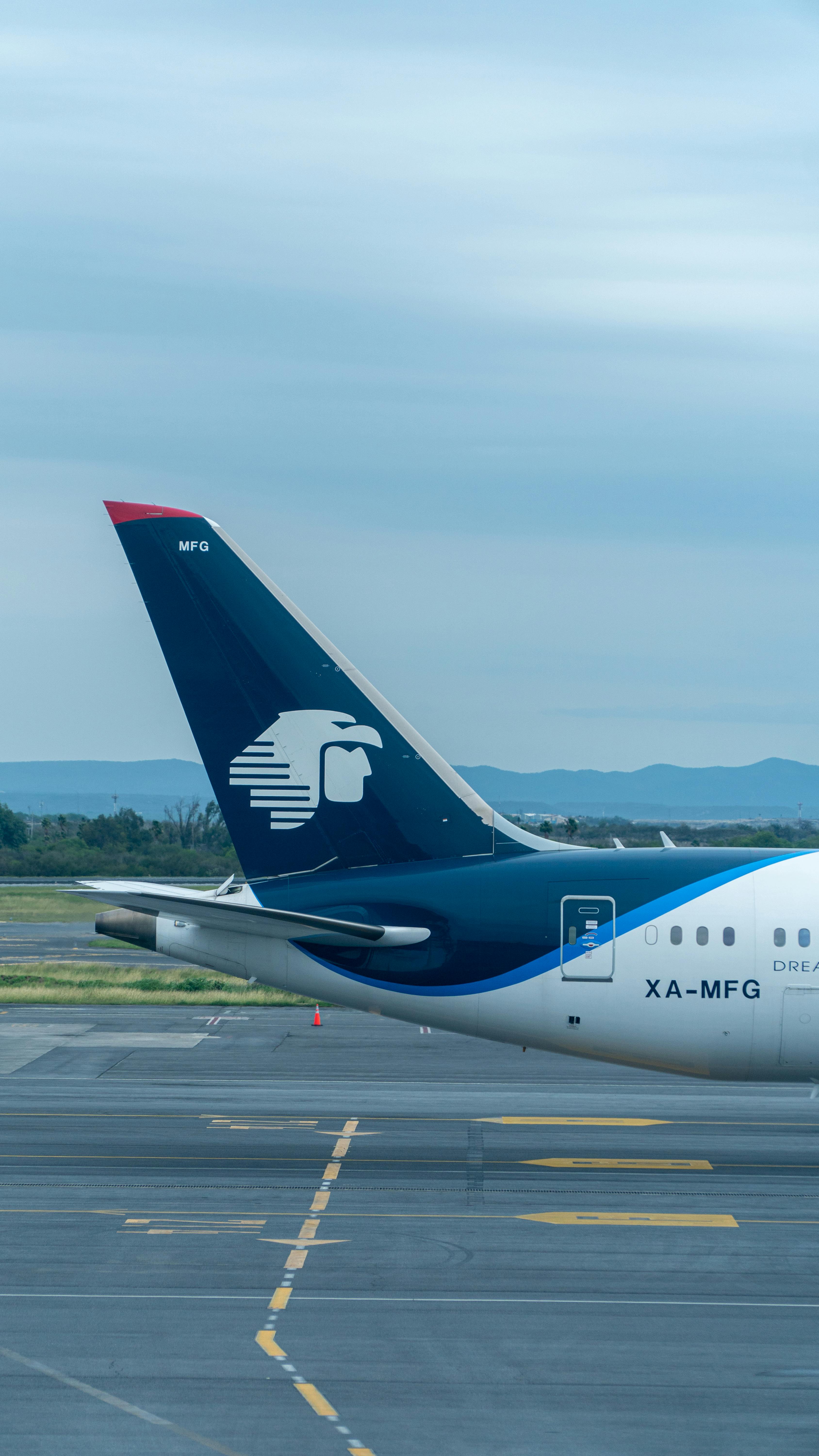 3376x6000 Clouds over Airplane on Tarmac · Free