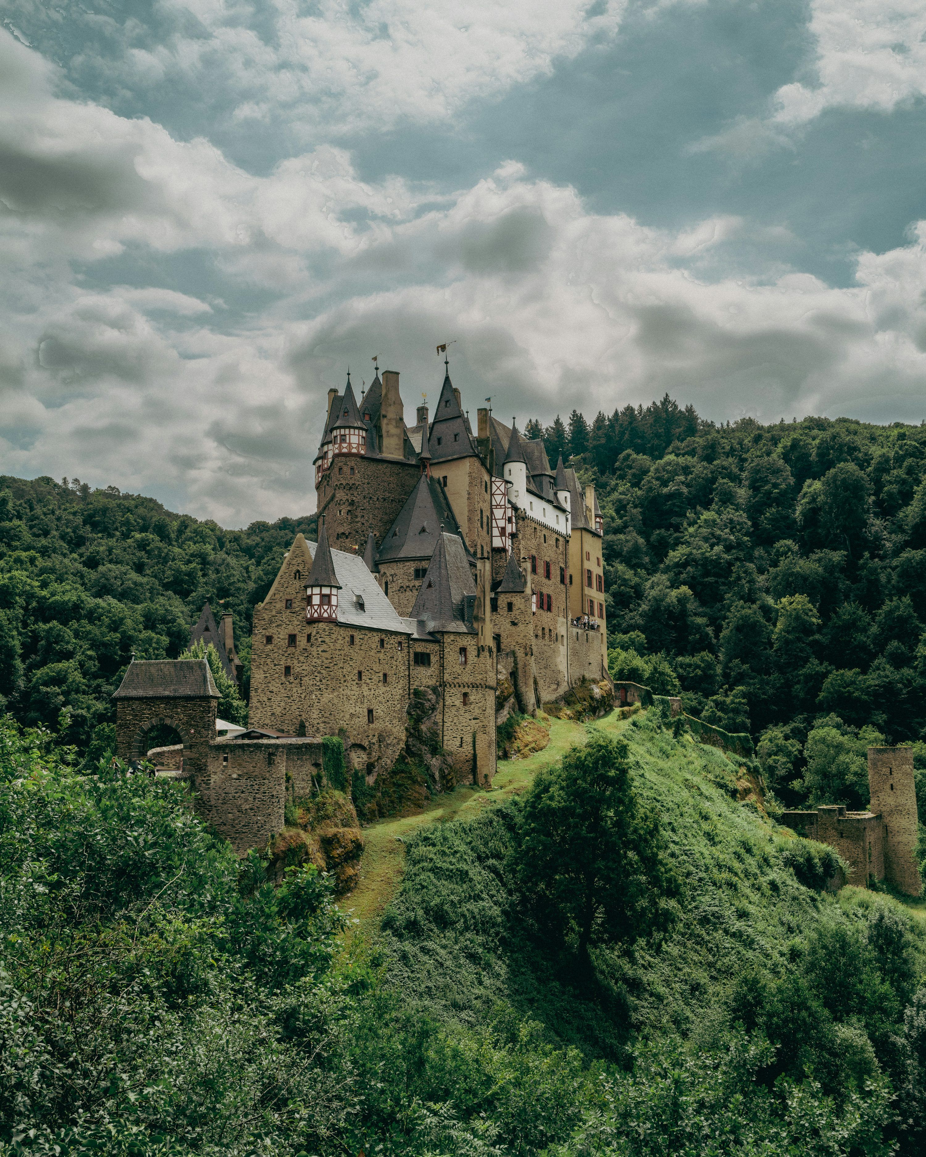 3000x3750 A majestic castle stands on a green hill. photo