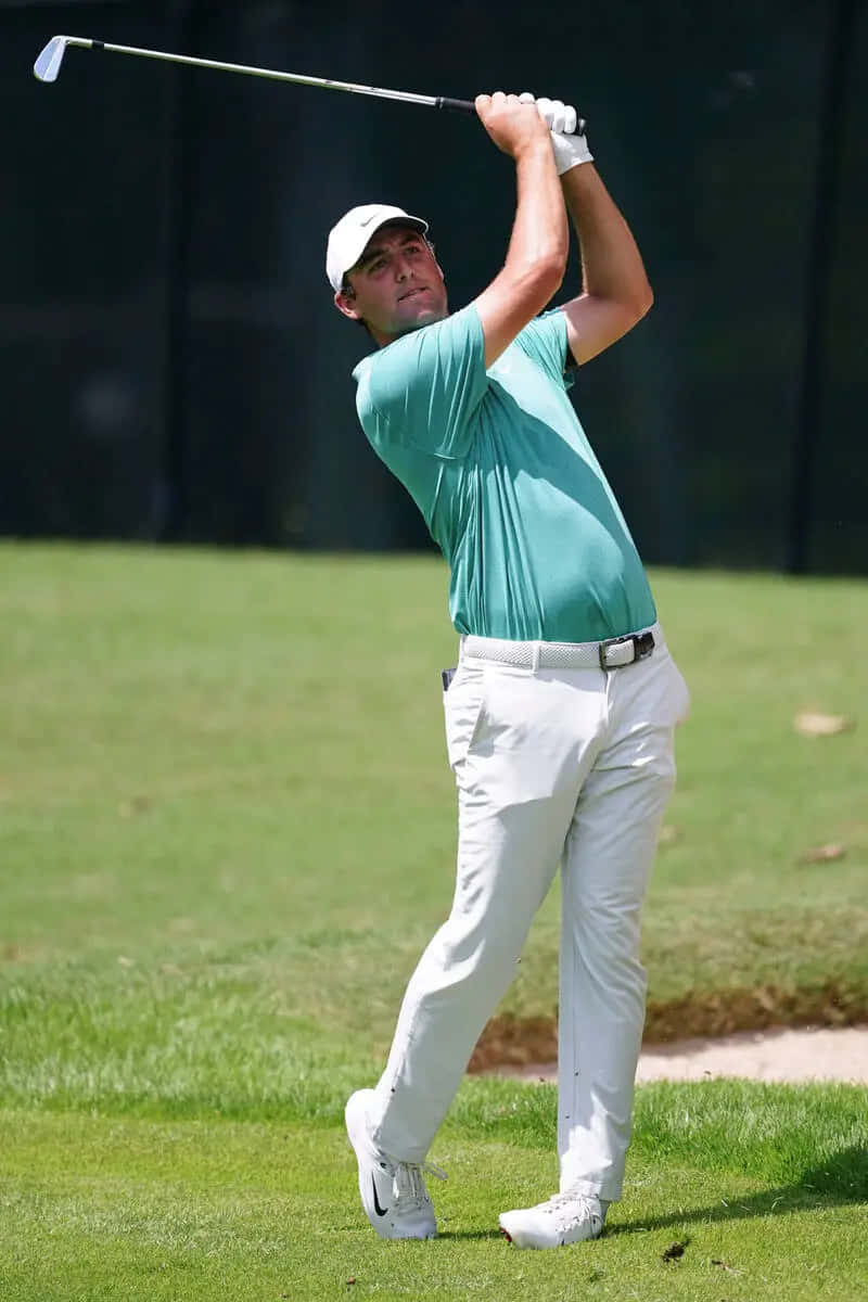 800x1200 Download Professional Golfer Scottie Scheffler In Action On The Course Wallpaper