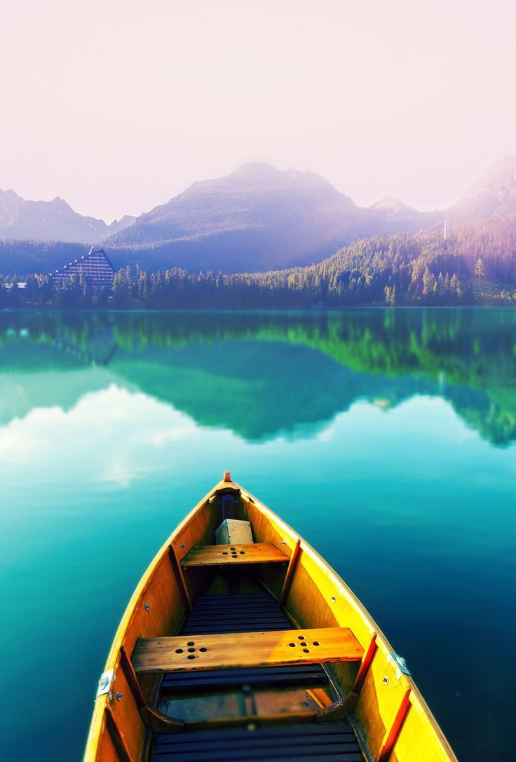 736x1087 Rowboat in blue water & mountains