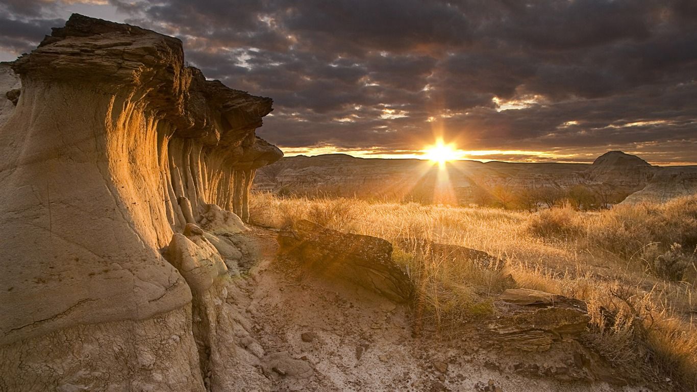 1366x768 Odd Shaped Rock Sunset Windows 10 HD Wallpaper