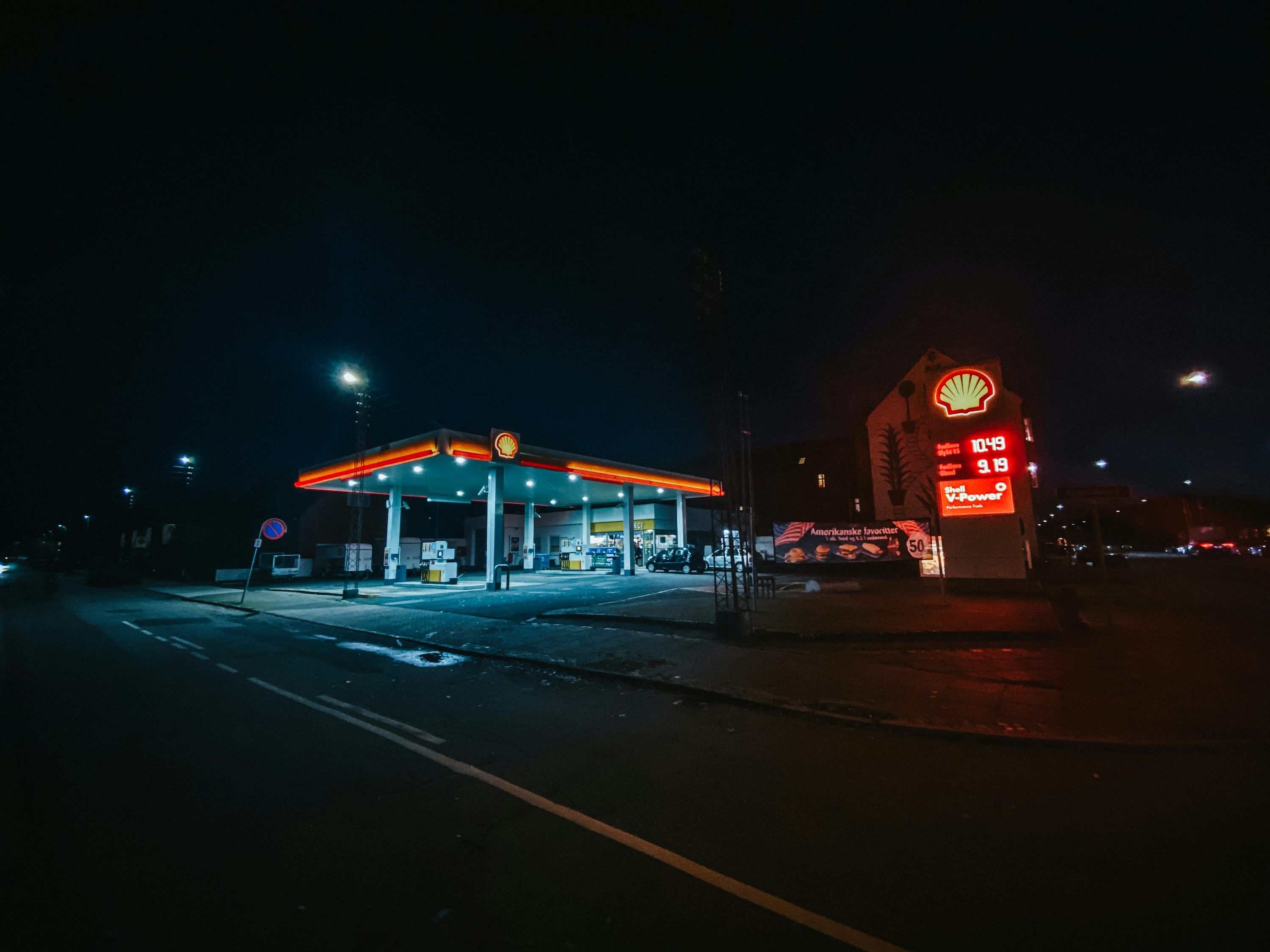 3000x2250 A gas station lit up at night time photo