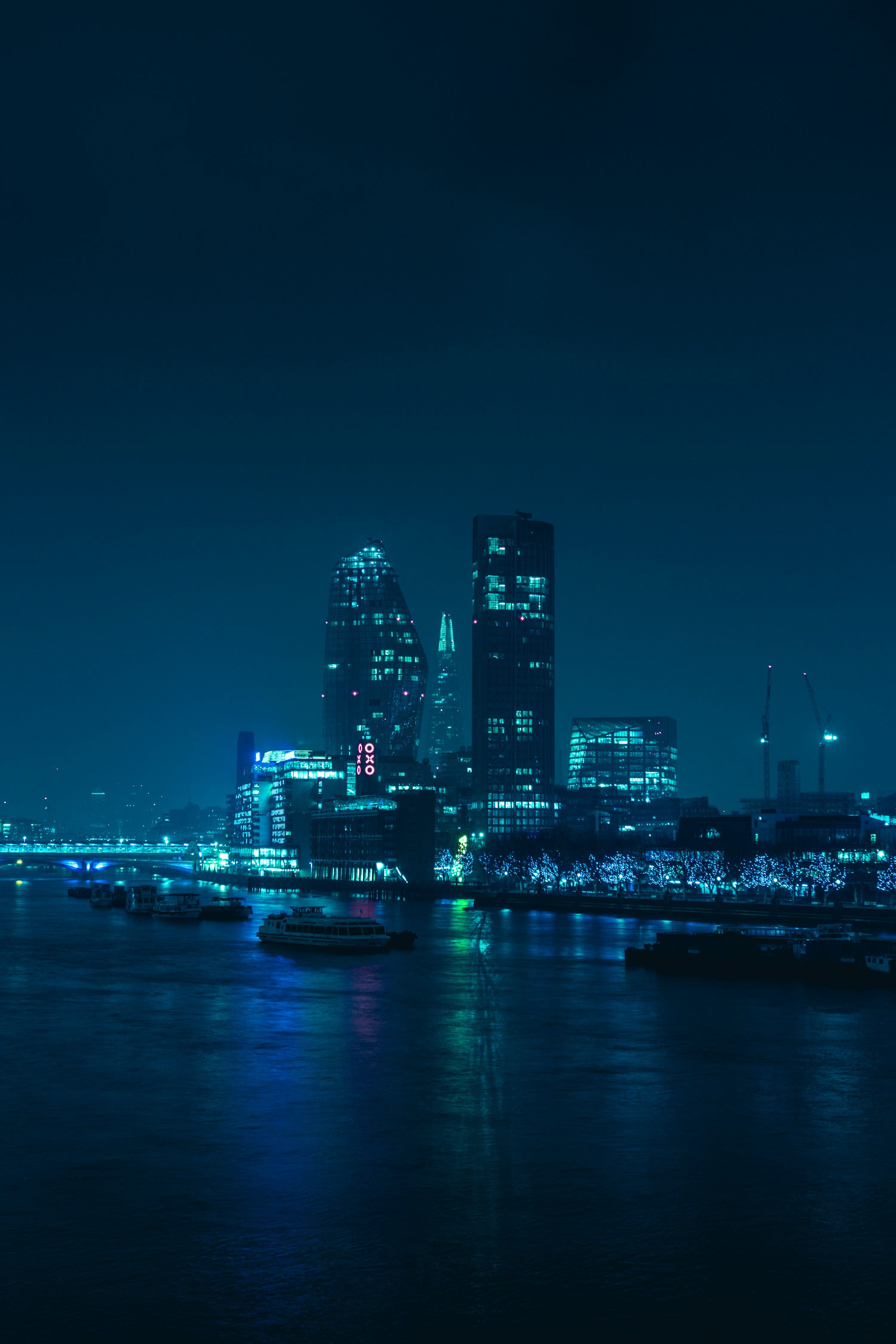 3000x4500 A view of a city at night from across the water photo