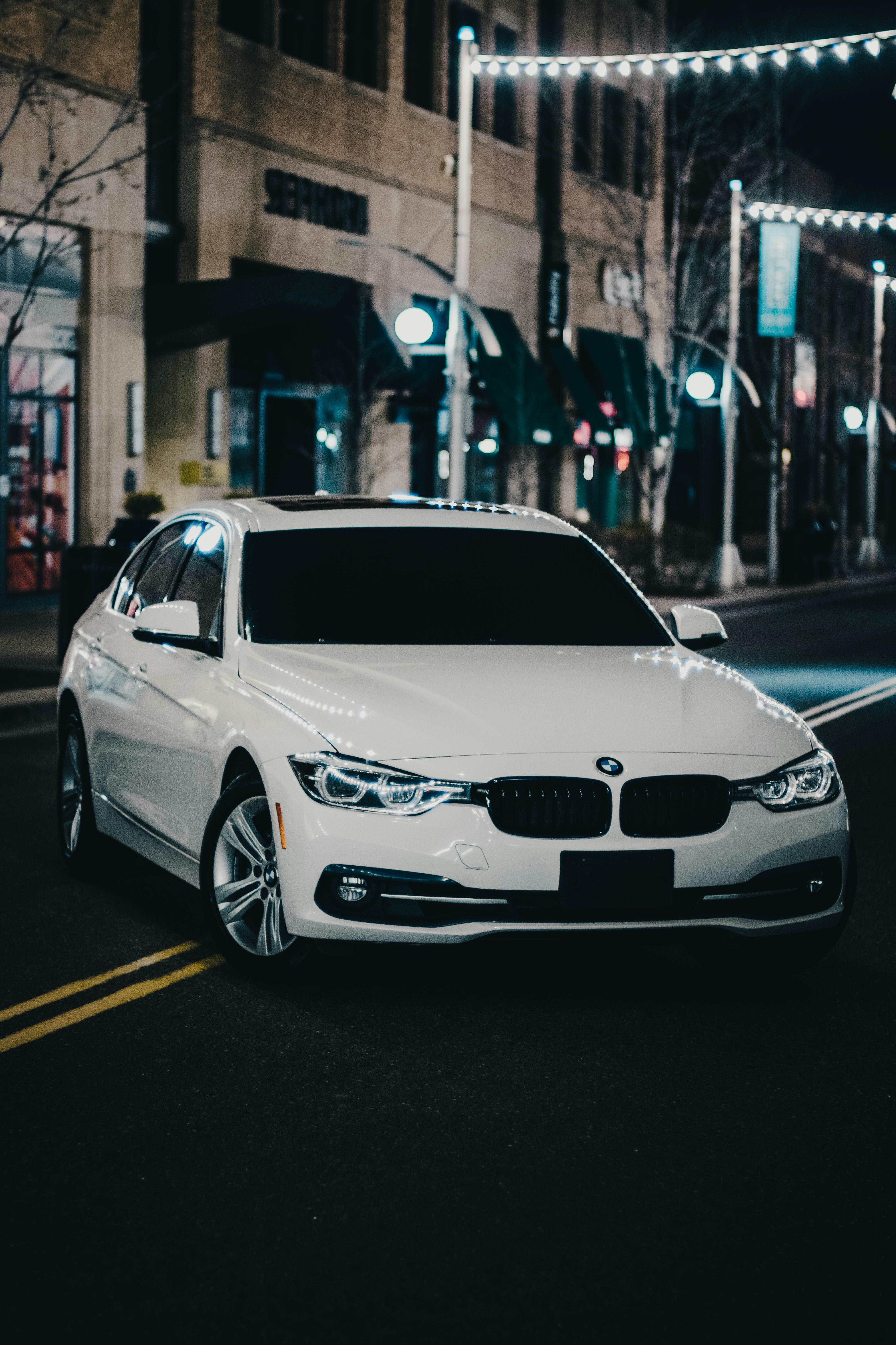 3577x5367 A White BMW on the Street at Night · Free