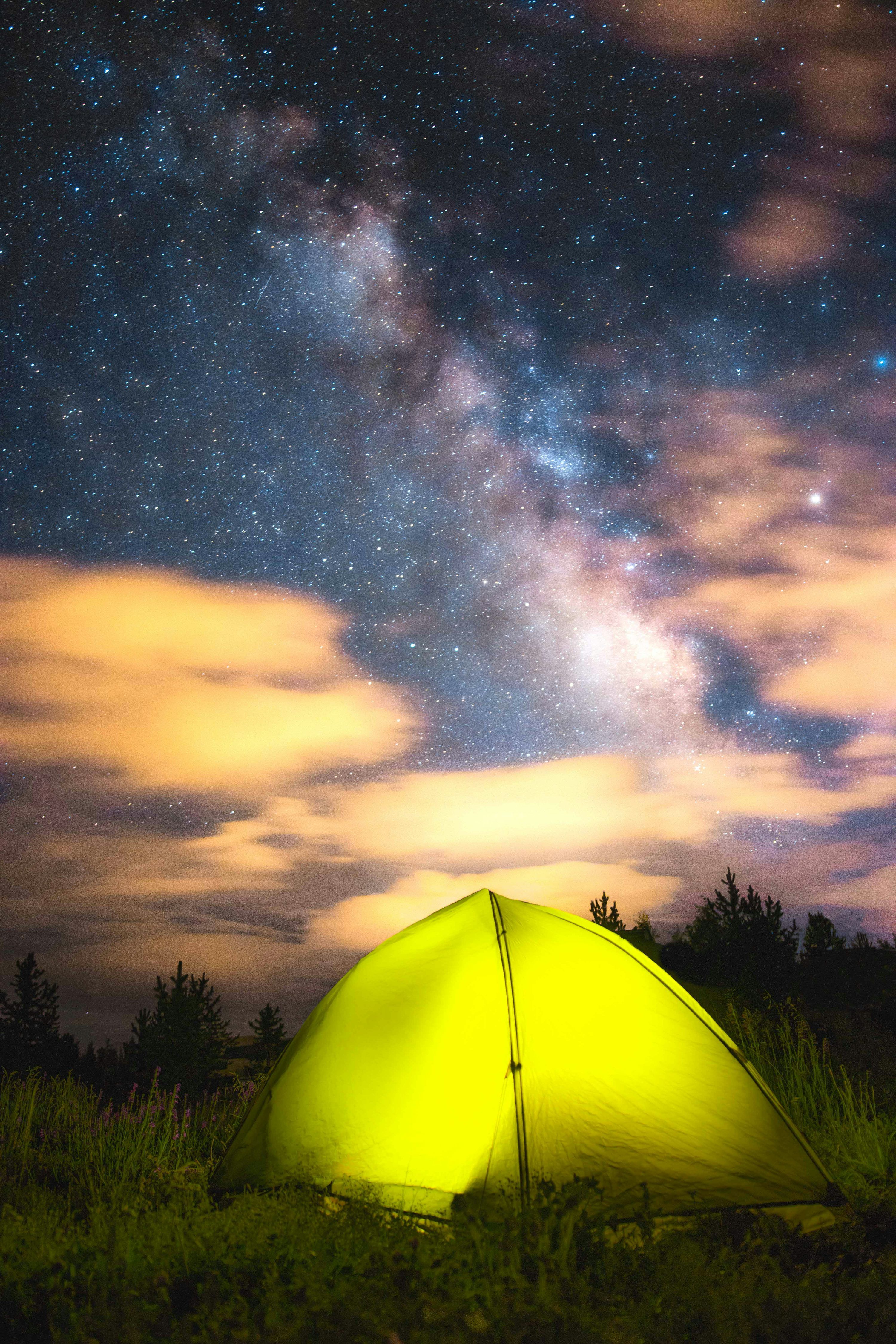 3000x4500 Yellow dome tent on green grass field under night sky photo