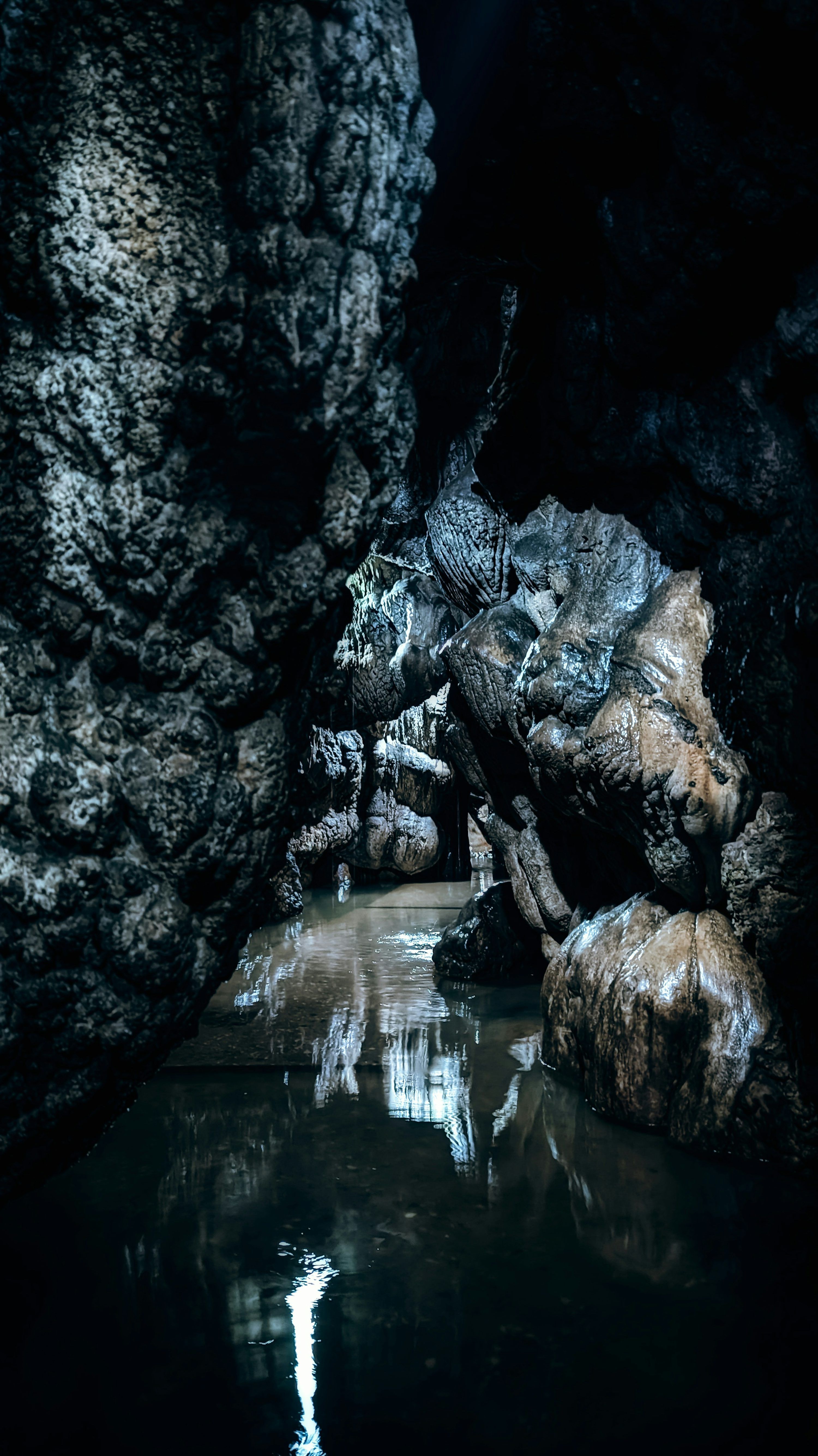 3000x5333 A cave with a waterfall photo
