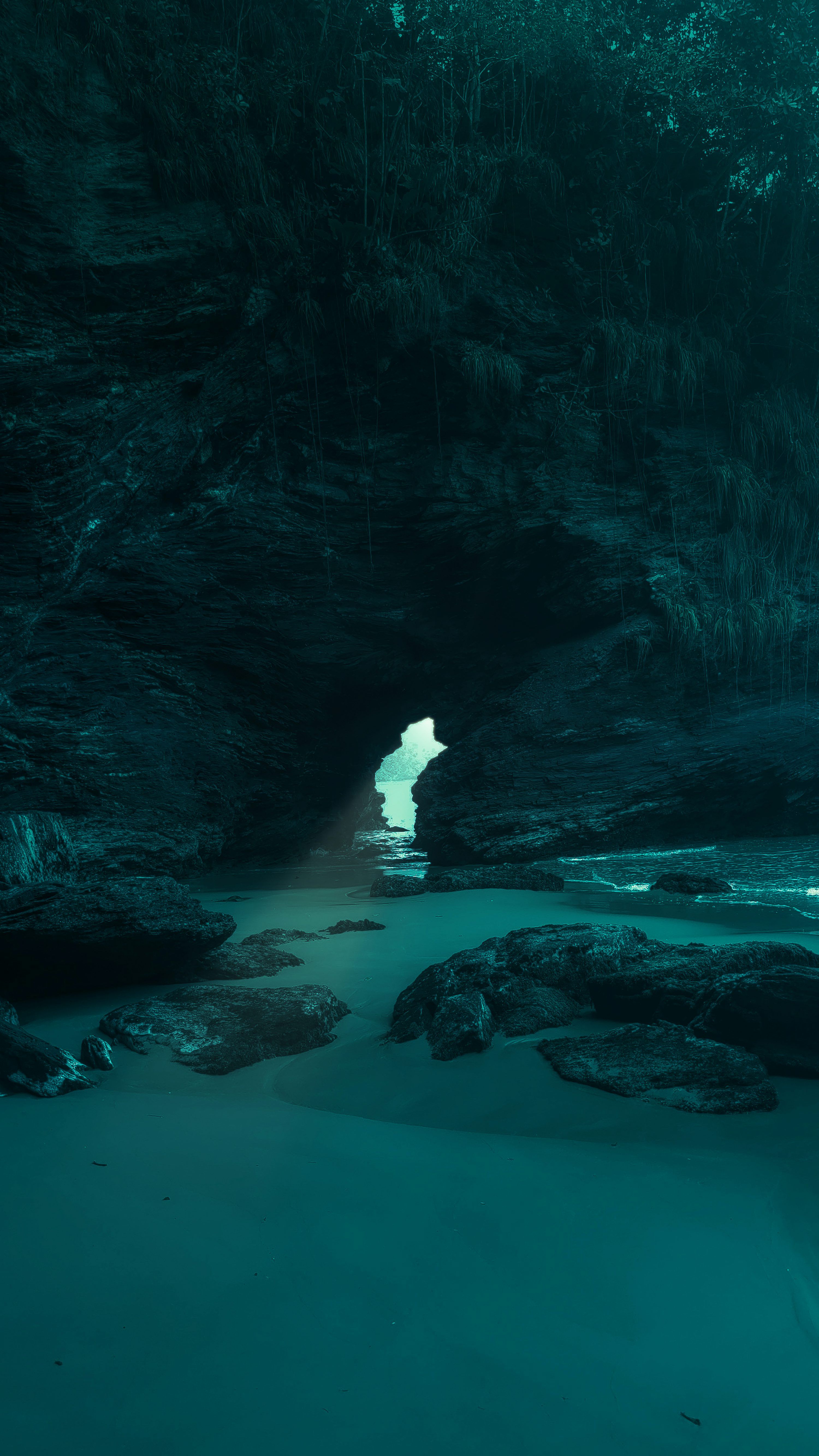 3000x5333 A cave with a body of water inside of it photo