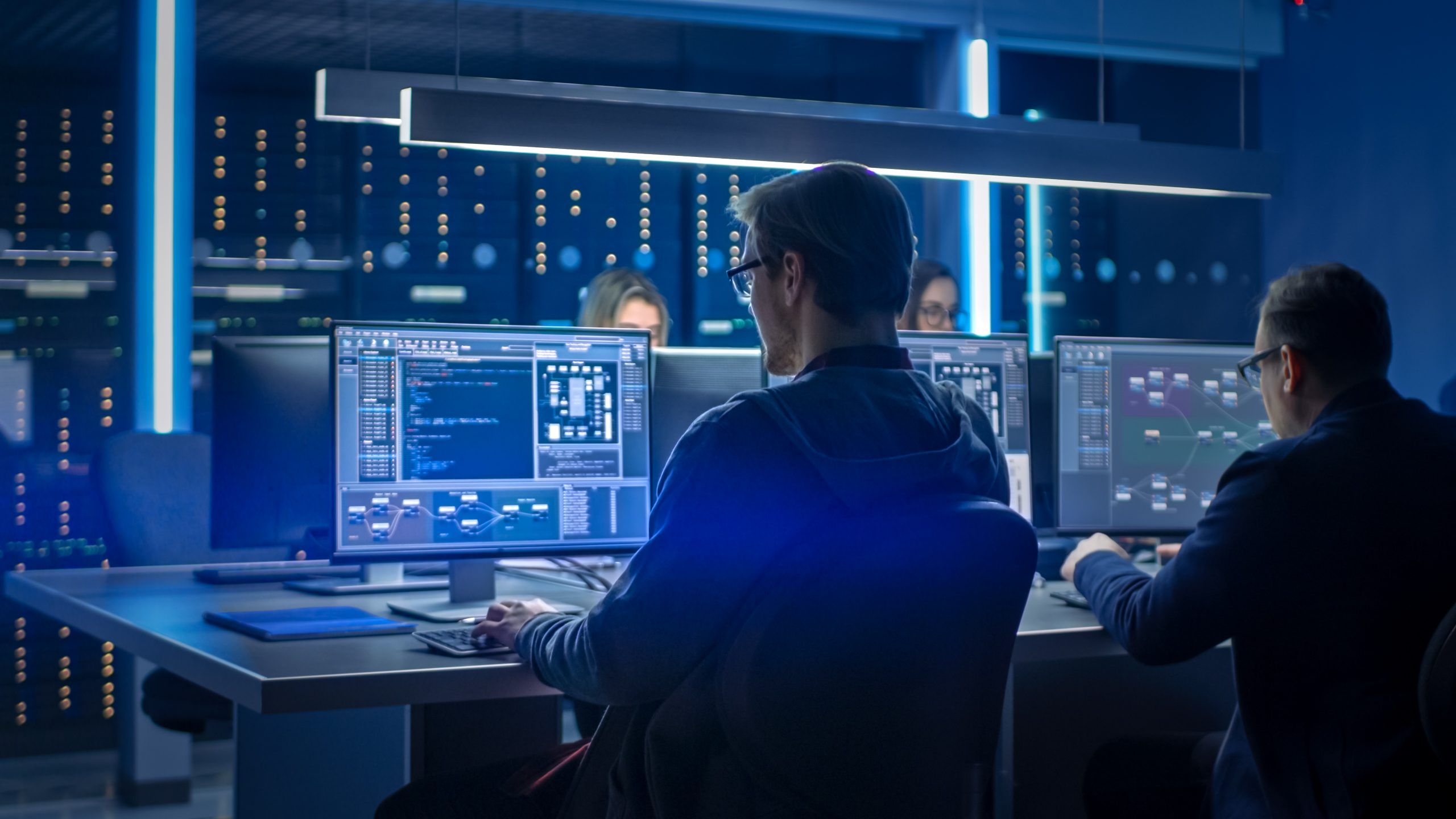 2560x1440 Team Of IT Programers Working On Desktop Computers In Data Center Control Room. Young Professionals Writing On Sophisticated Programming Code Language