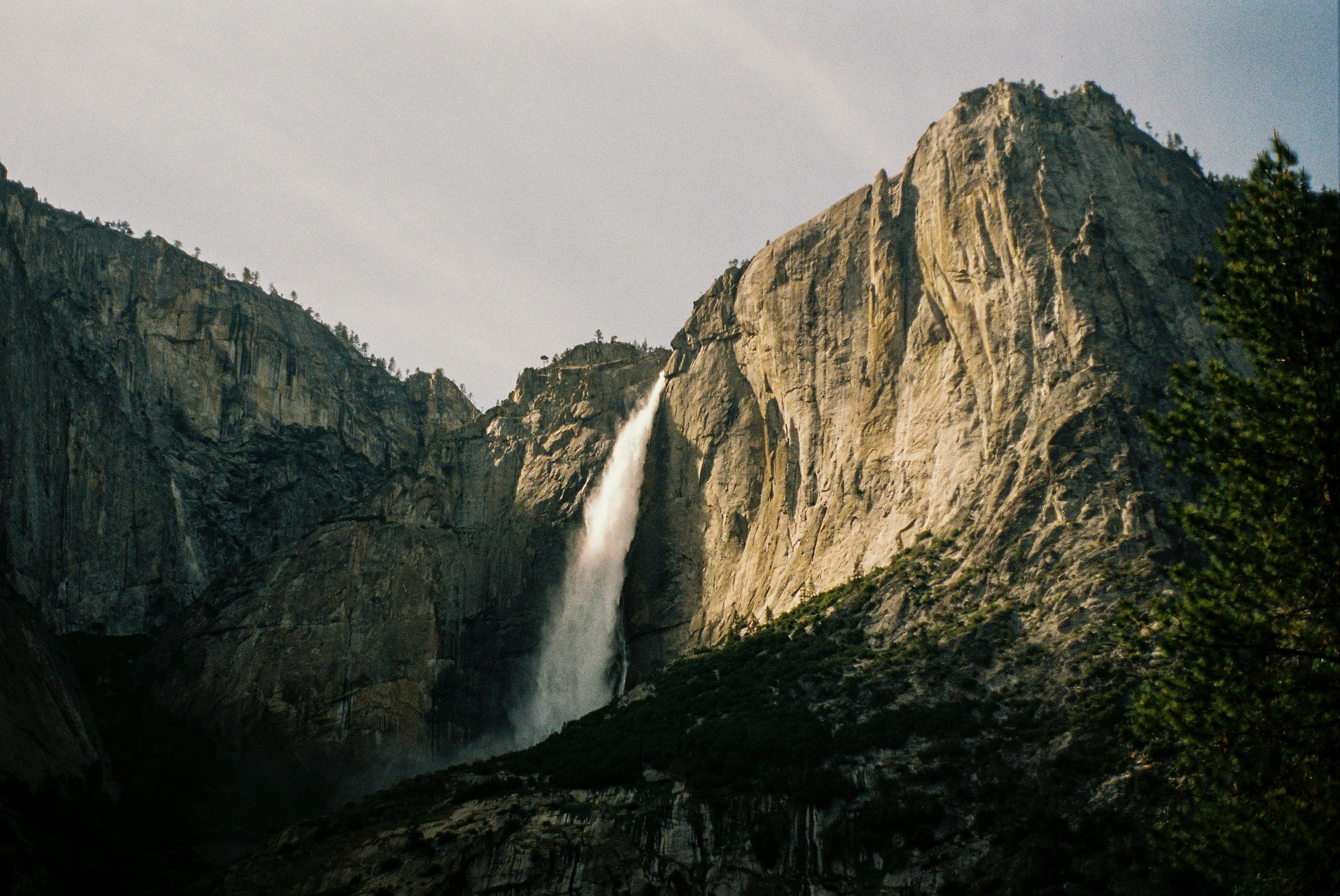 3000x2007 A large waterfall cascading over a mountain side photo