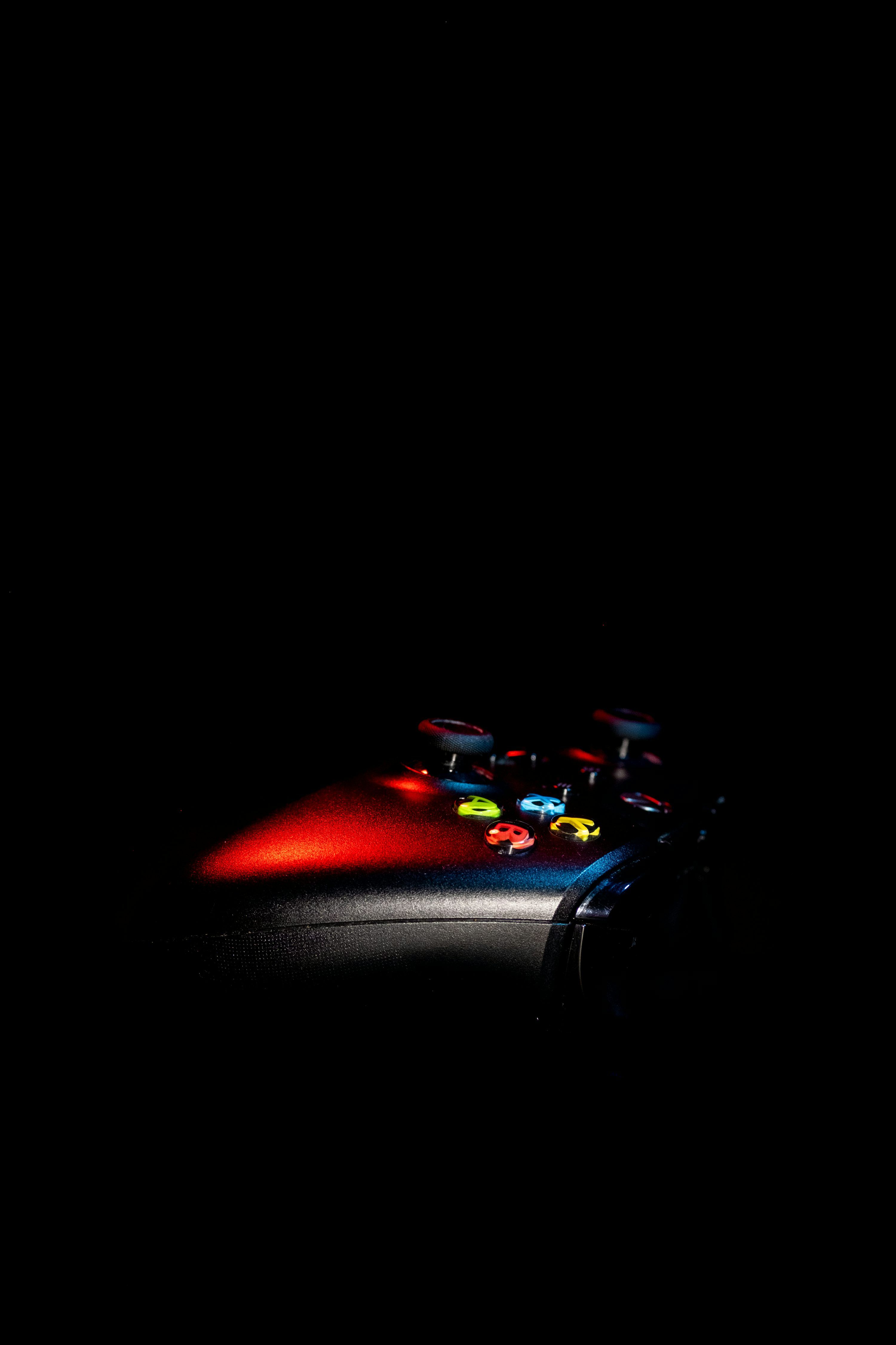 3000x4500 A close up of a remote control in the dark photo