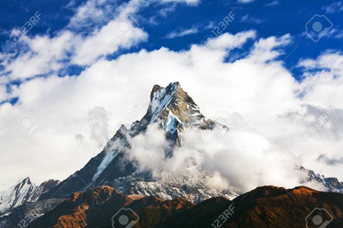 1300x866 Peak Machapuchare Over Clouds. Machapuchare Or Machhaphuchhare Is A Mountain In The Annapurna Himal Of North Central Nepal , Picture and Royalty Free Image. Image 43981295