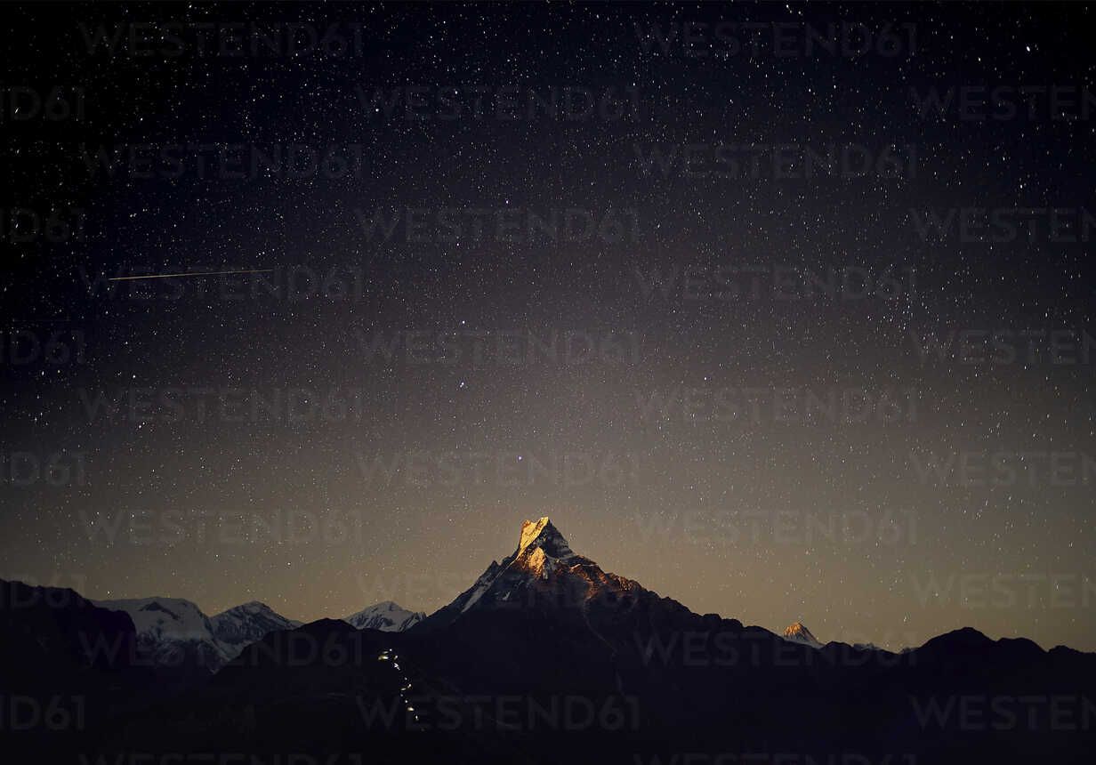 1232x860 Scenic view of Machapuchare Mountains against star field at night