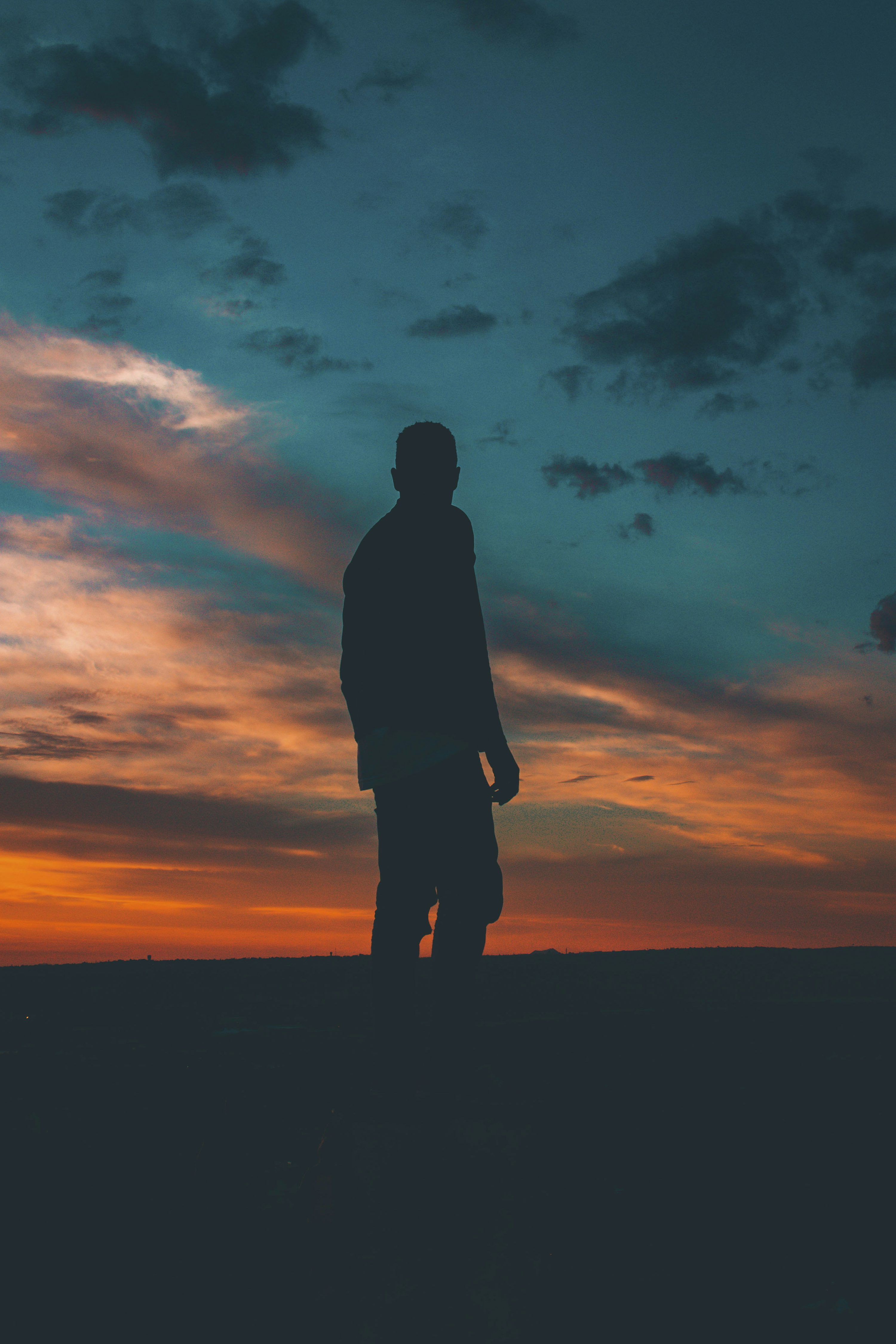 3000x4500 Silhouette on man standing on ground photo