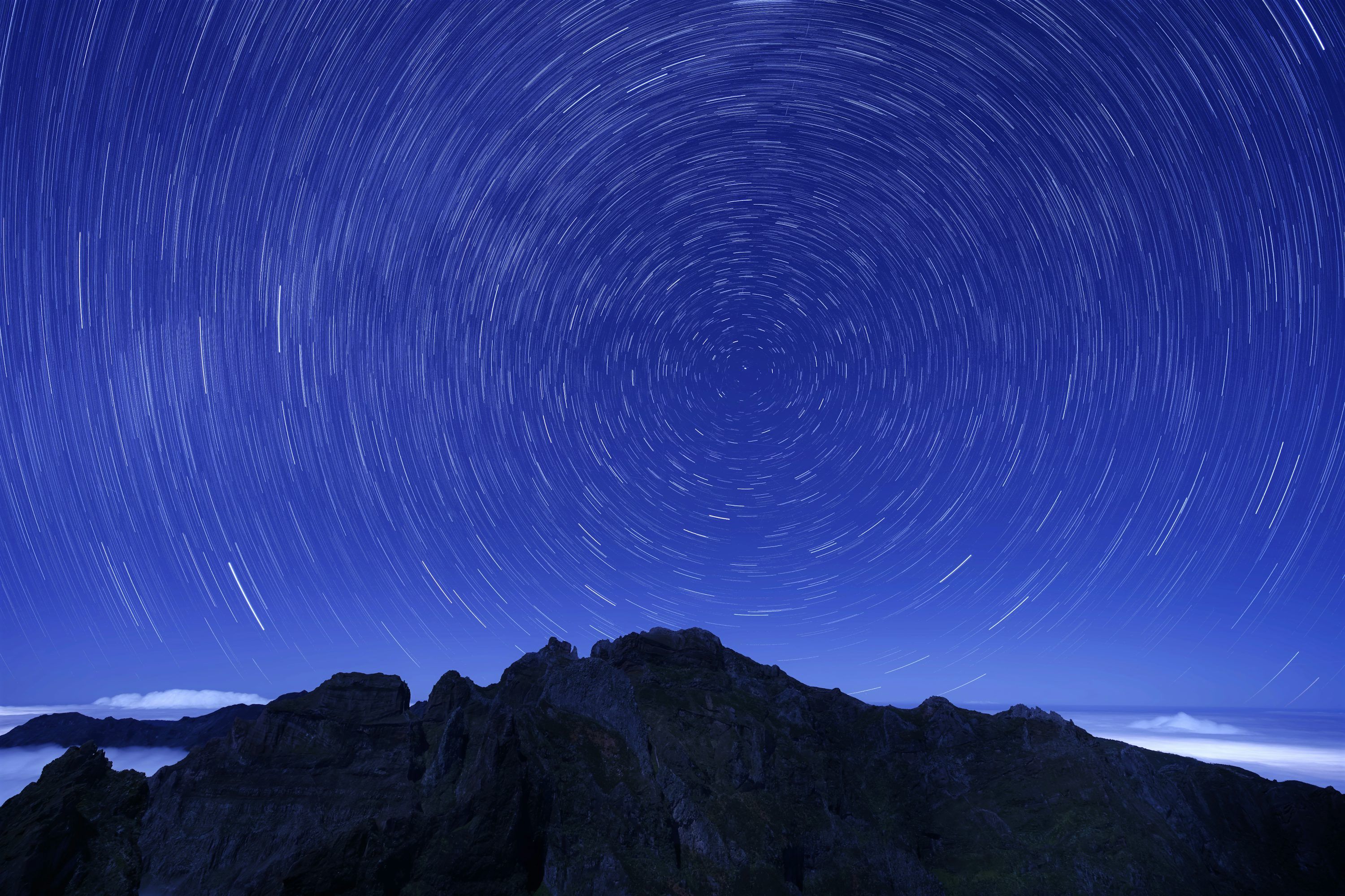 3000x2000 A mountain with a star trail in the sky photo