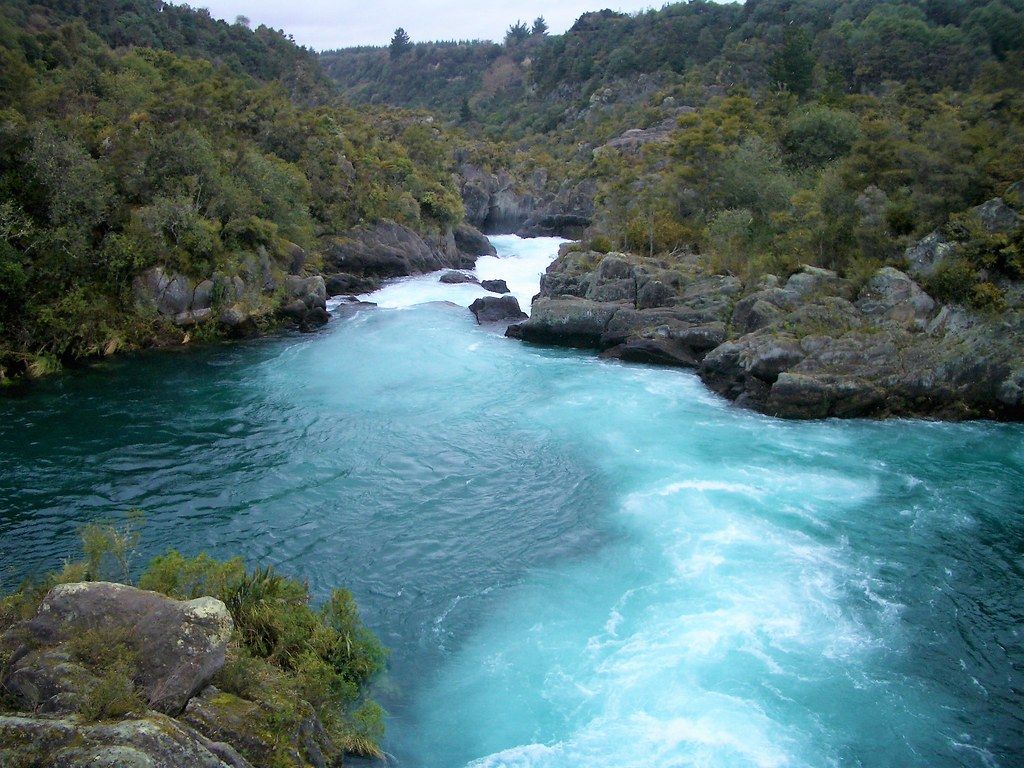 1024x768 Rotorua New Zealand. Fast flowing river with glacial bloom
