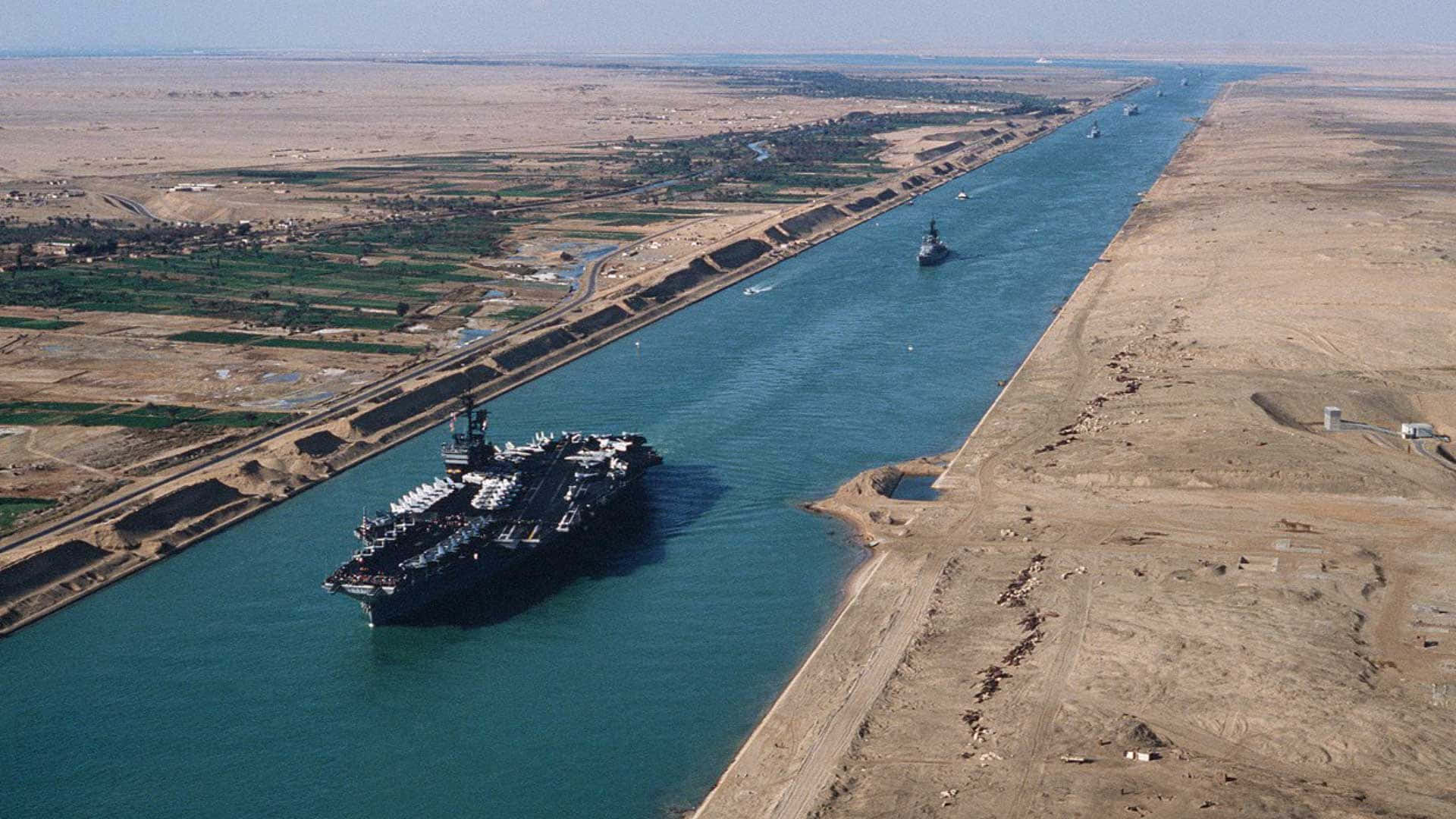 1920x1080 Download A Ship Is Traveling Down A Canal In The Desert