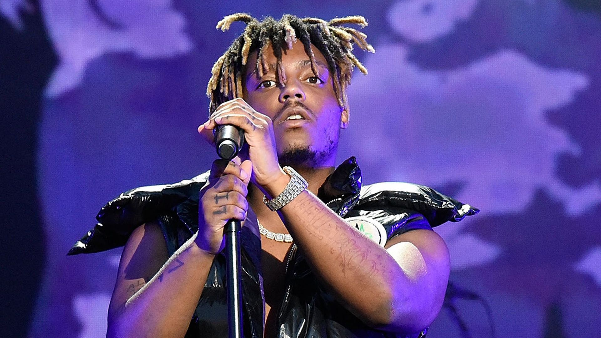 1920x1080 Juice Wrld Is Holding Mike With Hand Wearing Black Jacket Standing In Purple Background HD Juice Wrld Wallpaper